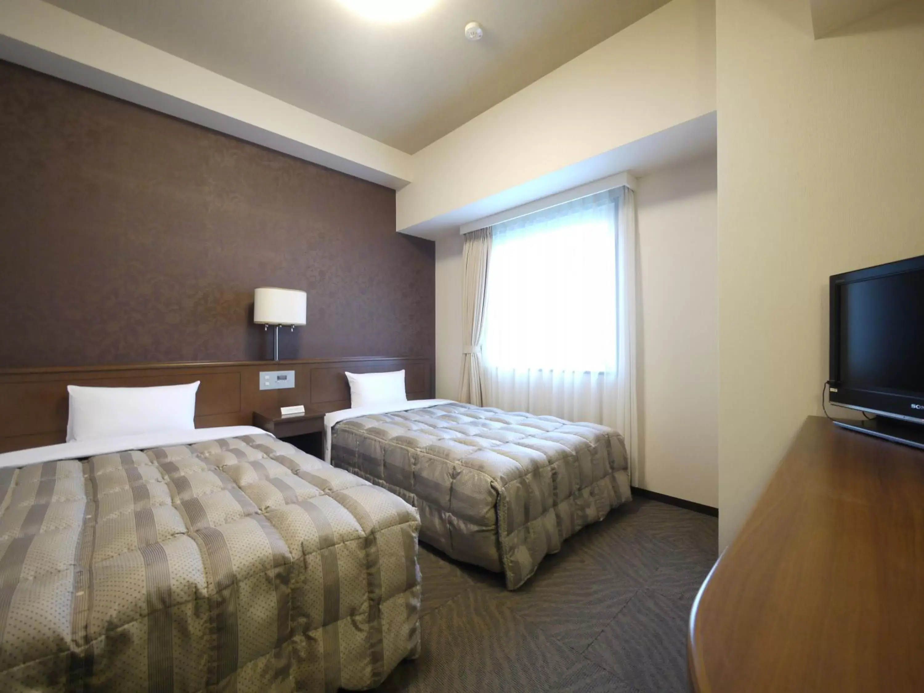 Bed in Hotel Route-Inn Fukui Ekimae