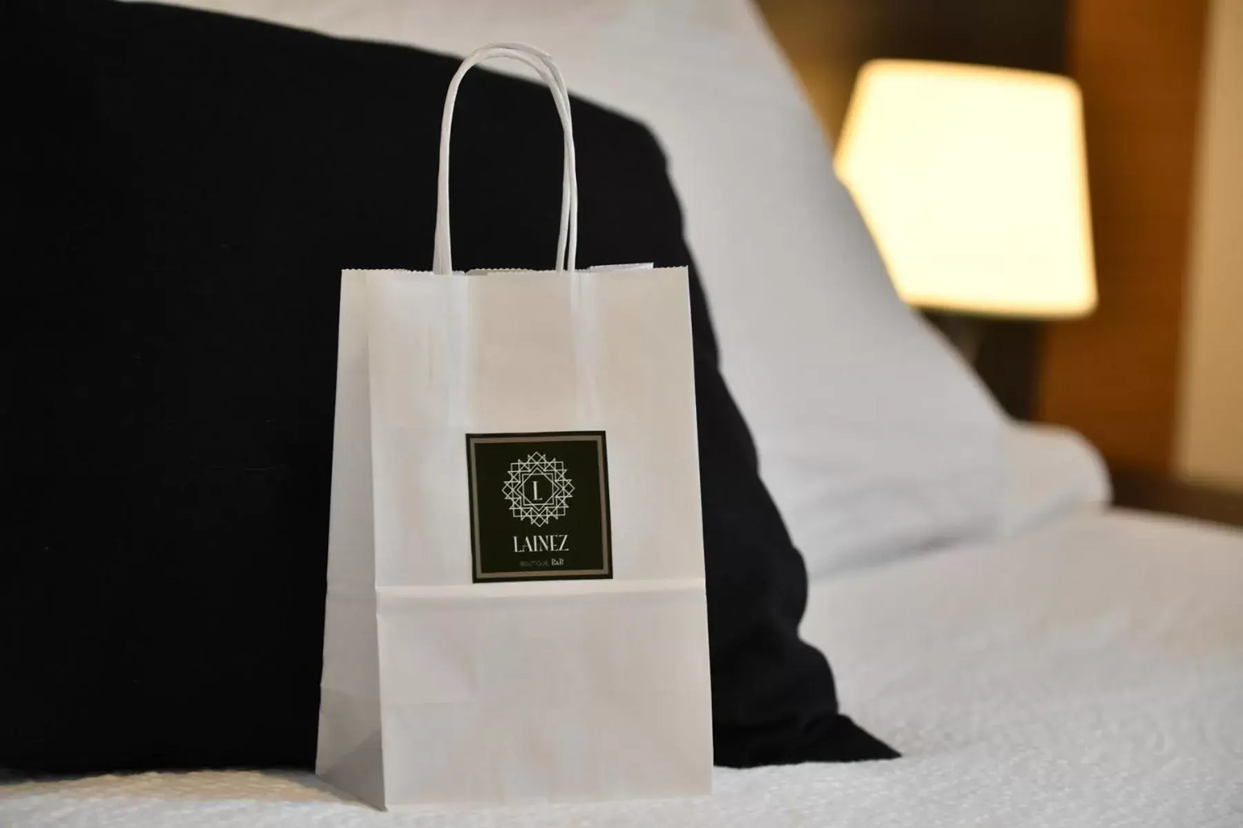 Property logo or sign, Bed in Lainez Rooms & Suites