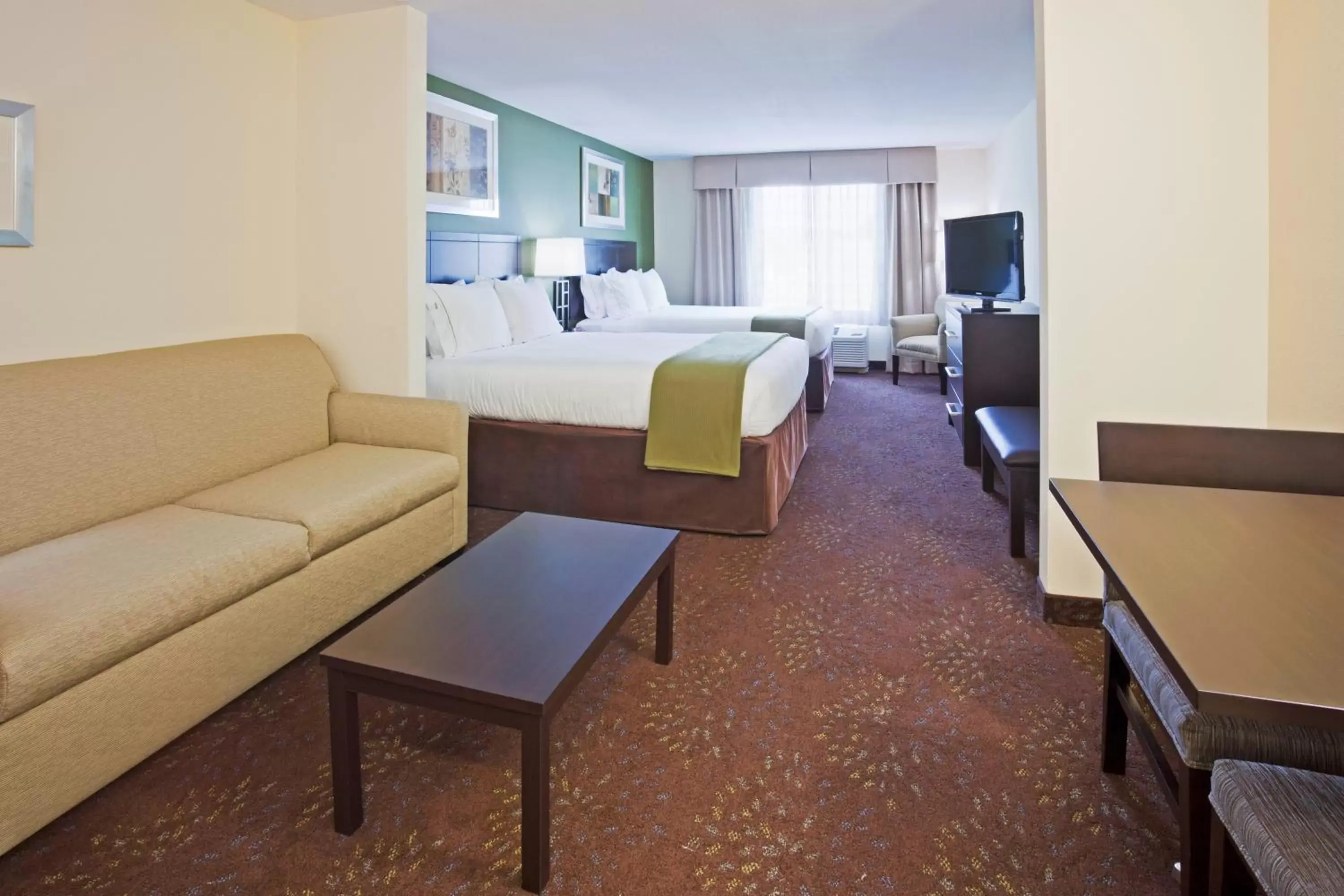 Bedroom, Seating Area in Holiday Inn Express and Suites Rochester West-Medical Center, an IHG Hotel
