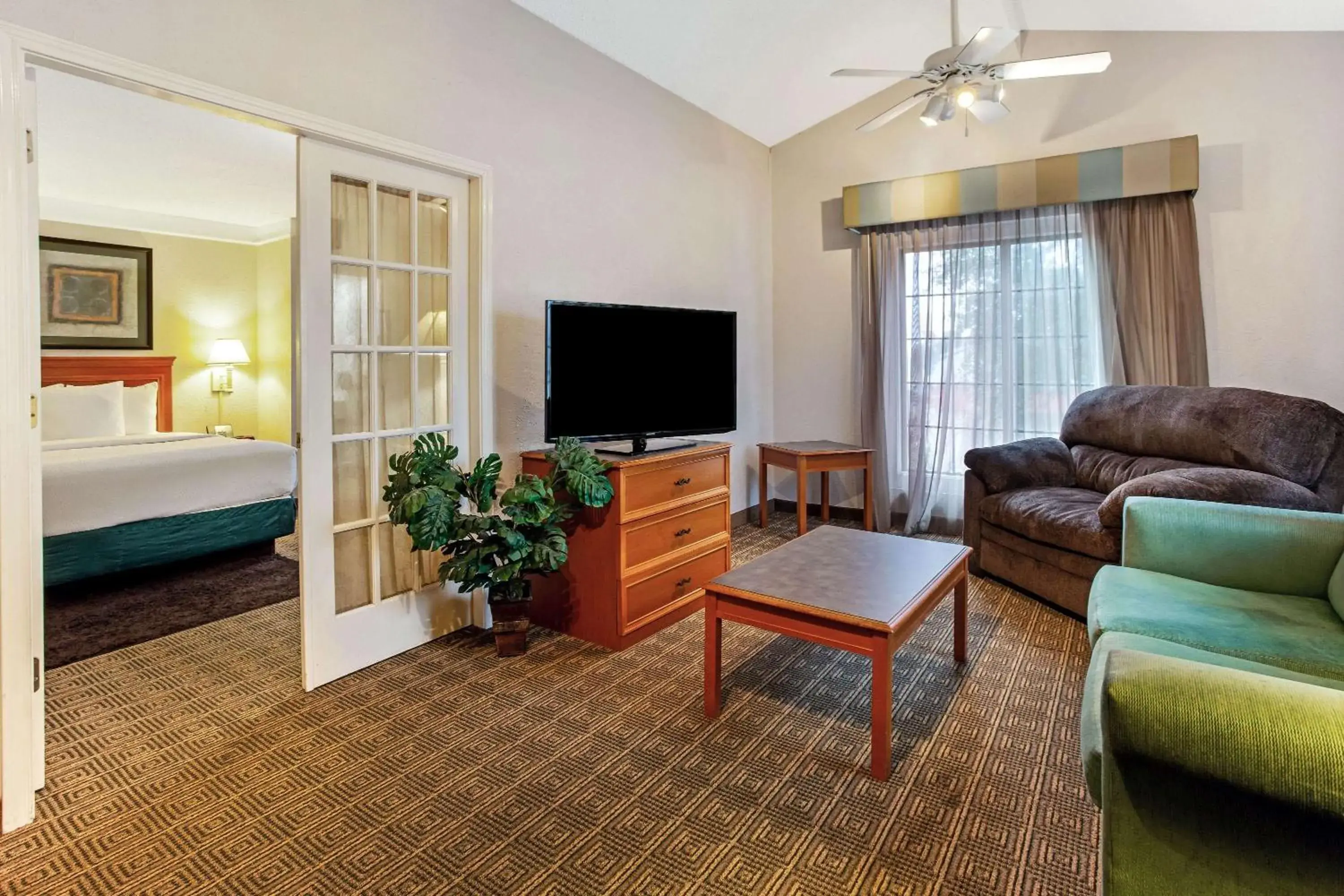 Photo of the whole room, TV/Entertainment Center in La Quinta Inn by Wyndham College Station