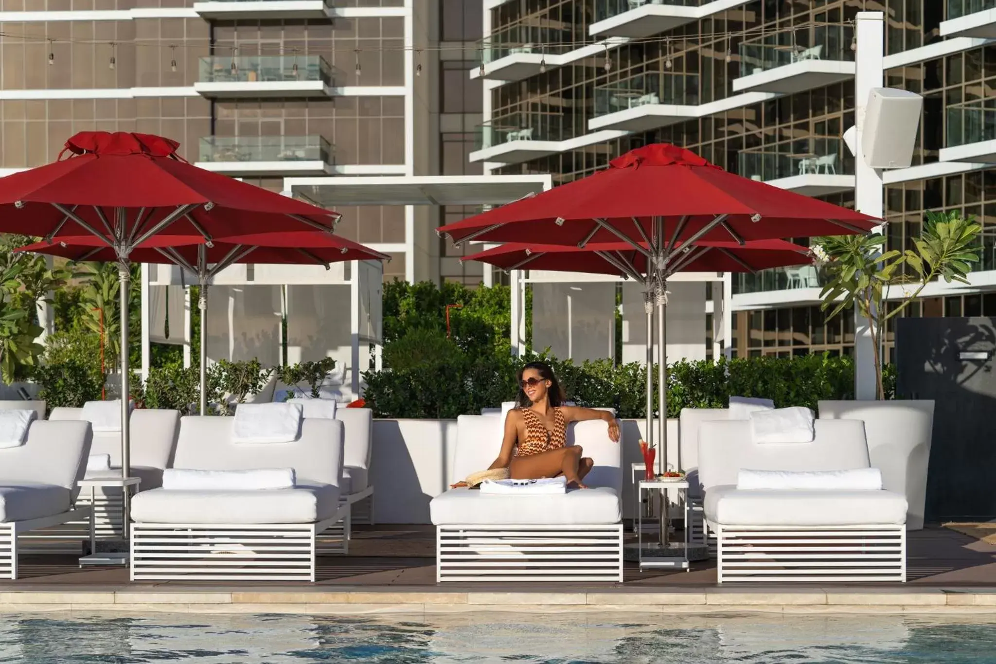 Swimming pool in Th8 Palm Dubai Beach Resort Vignette Collection, an IHG hotel