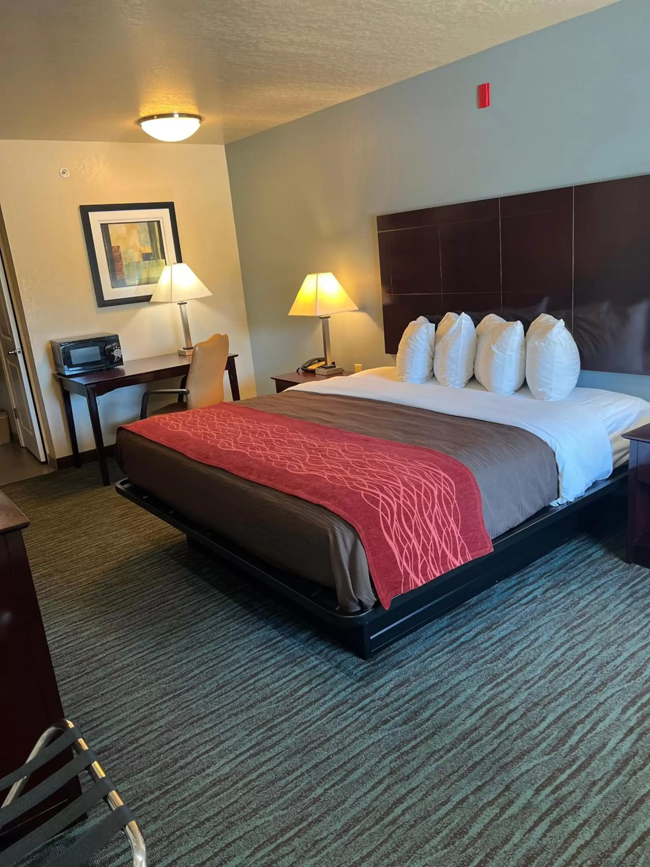 Bed in Garden Inn and Suites