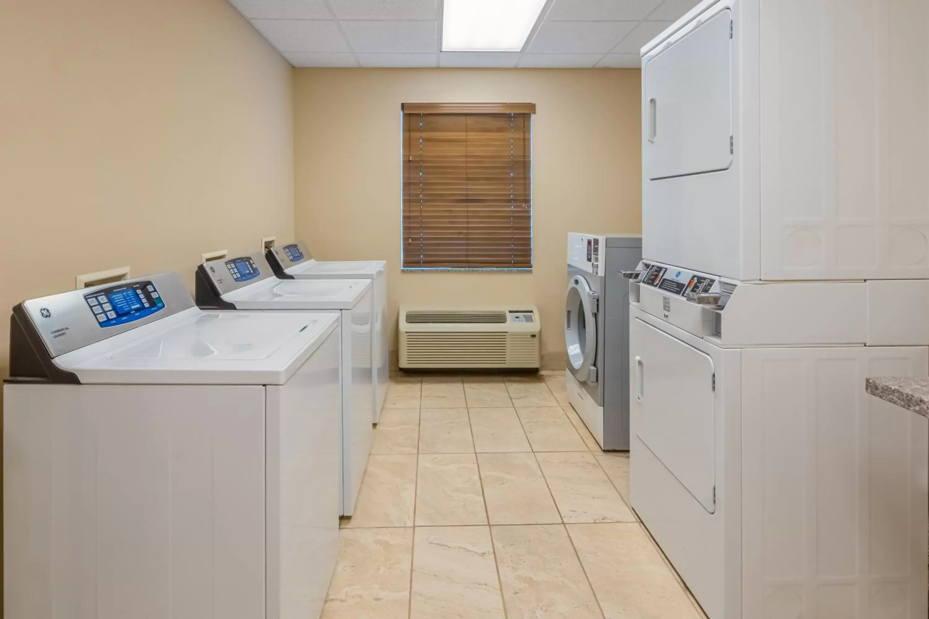 laundry, Kitchen/Kitchenette in Landmark Suites - Williston