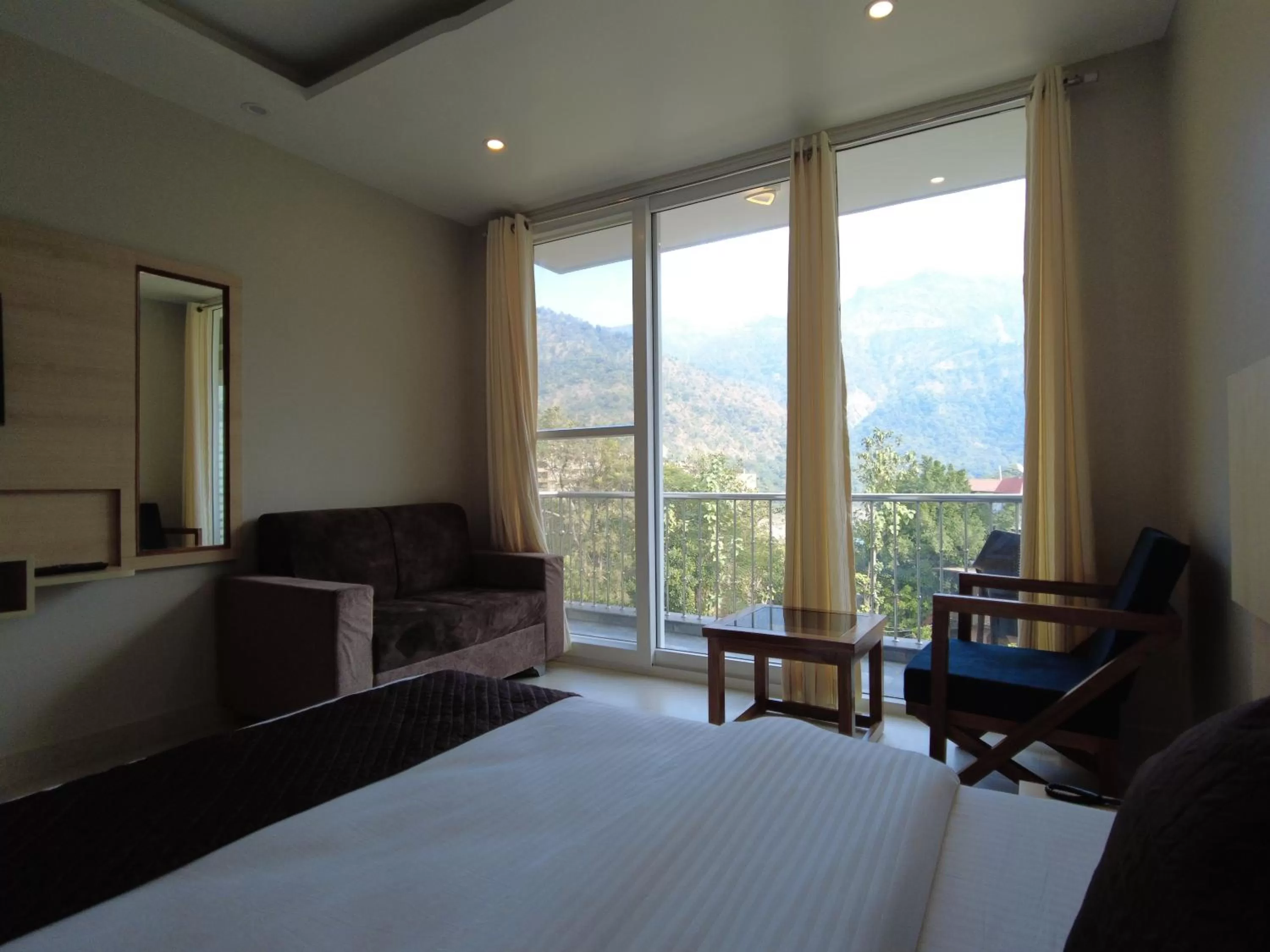 Seating area, Bed in Punyah Residency Rishikesh