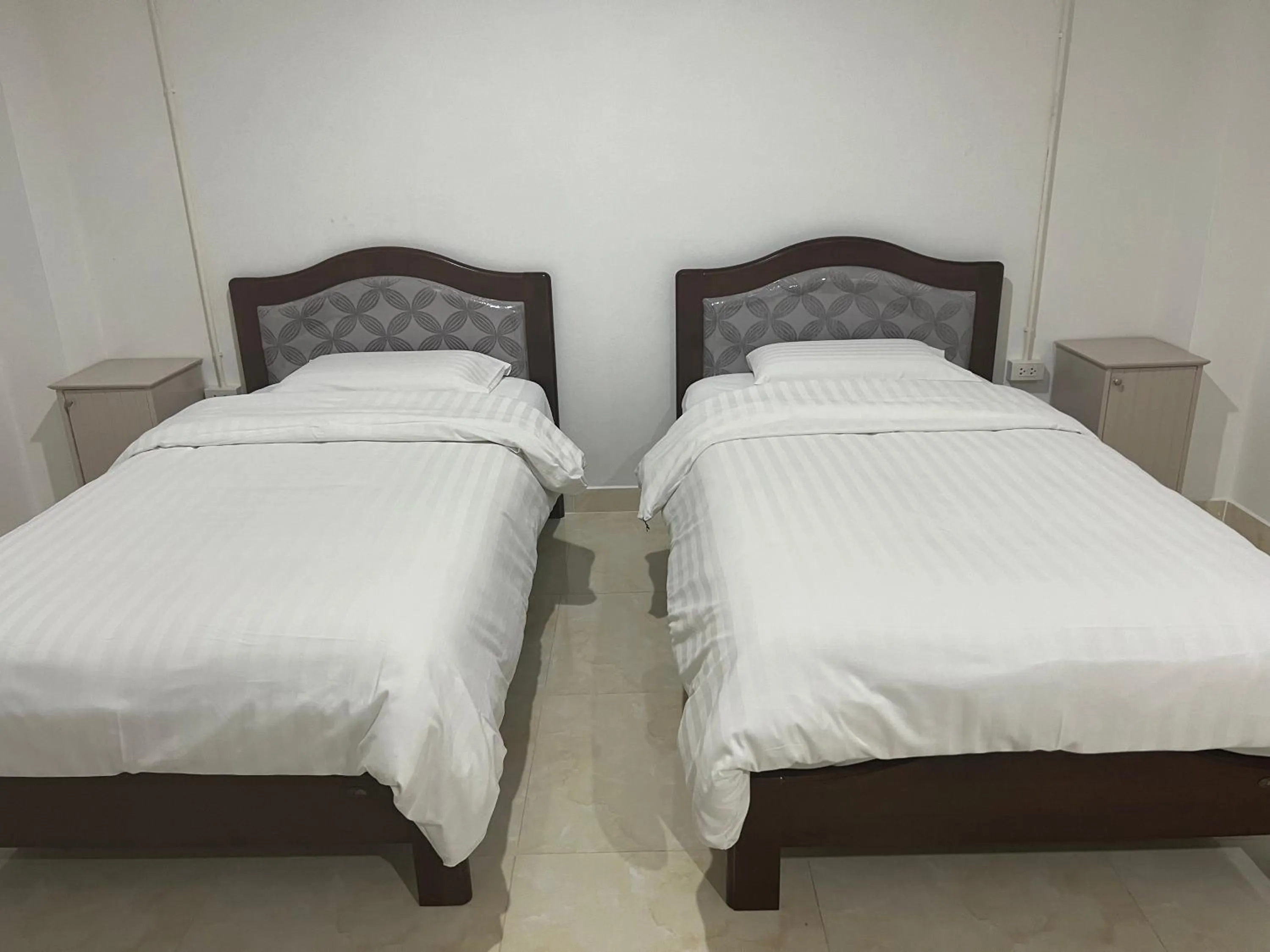 Bed in Mall Suites Hotel