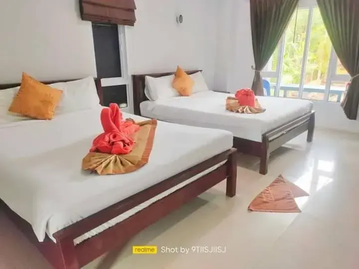 Bed in Tamarind Twin Resort