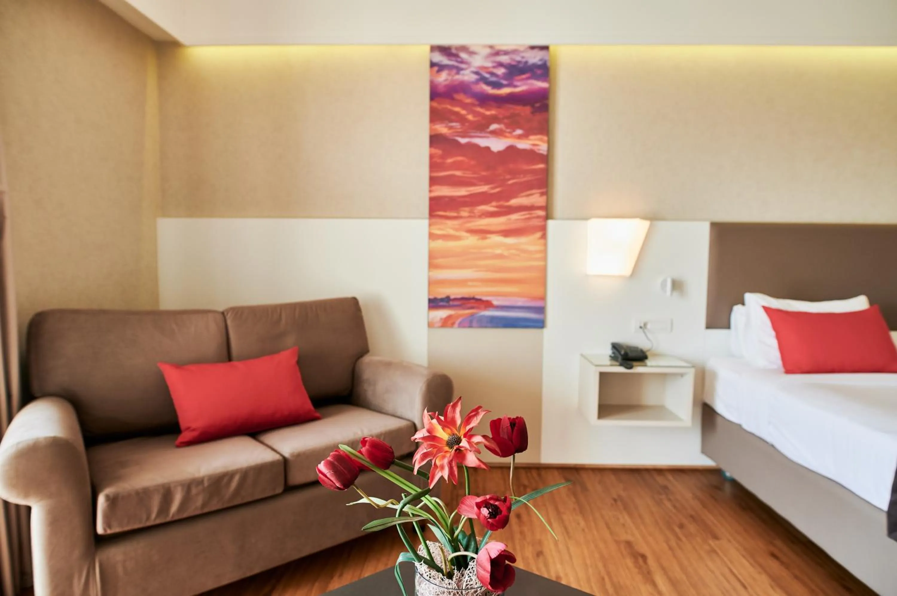 Seating area, Bed in Ramada Plaza by Wyndham Thraki