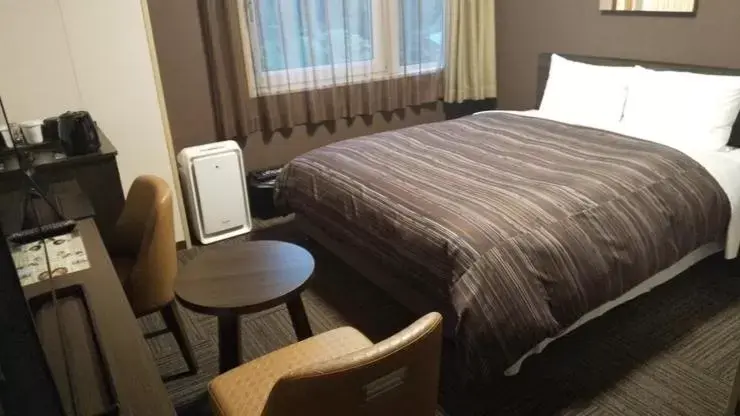 Bed in Hotel Route-Inn Higashiomi Yokaichi Ekimae