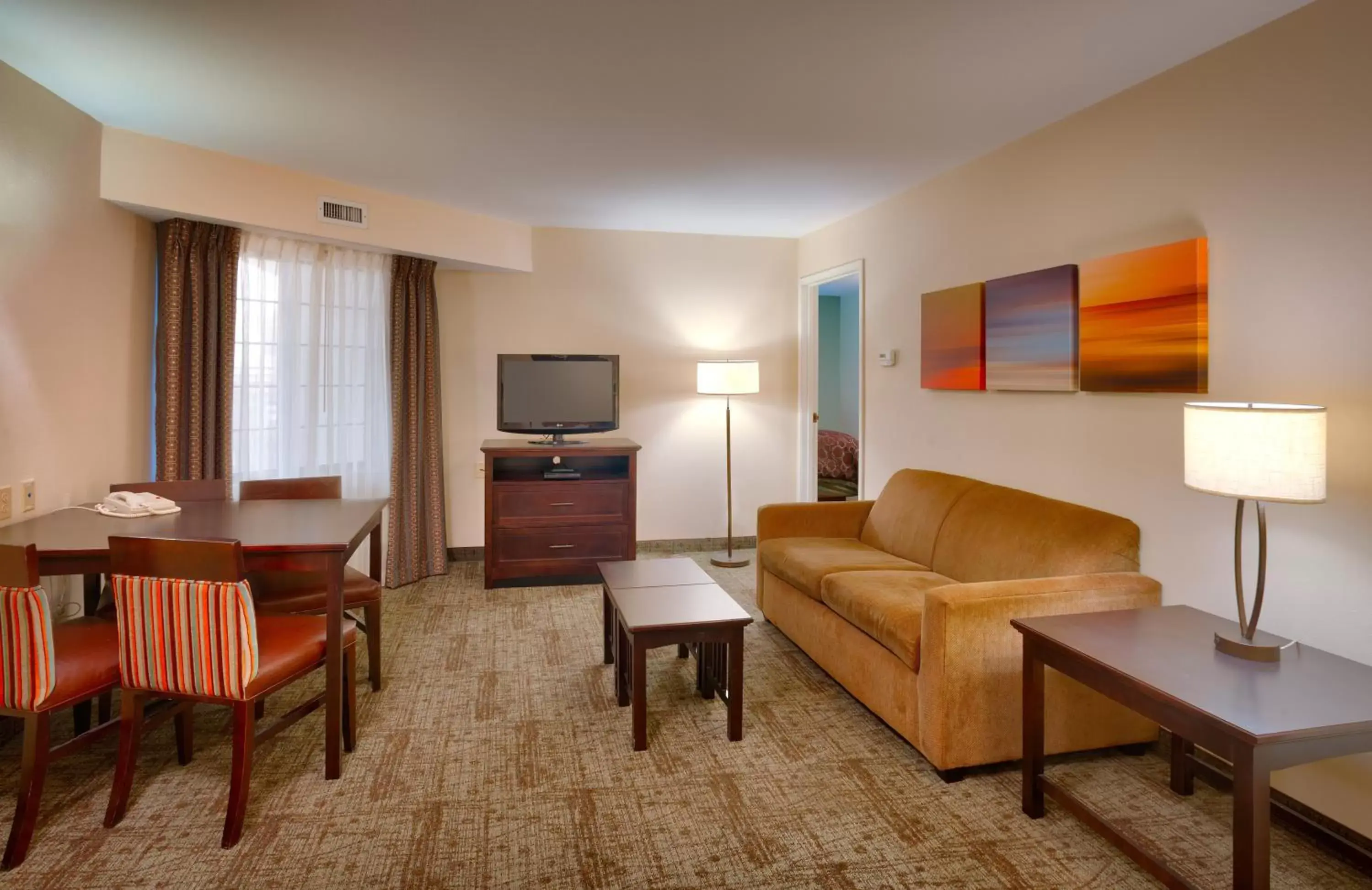 Bedroom, Seating Area in Staybridge Suites Peoria Downtown, an IHG Hotel
