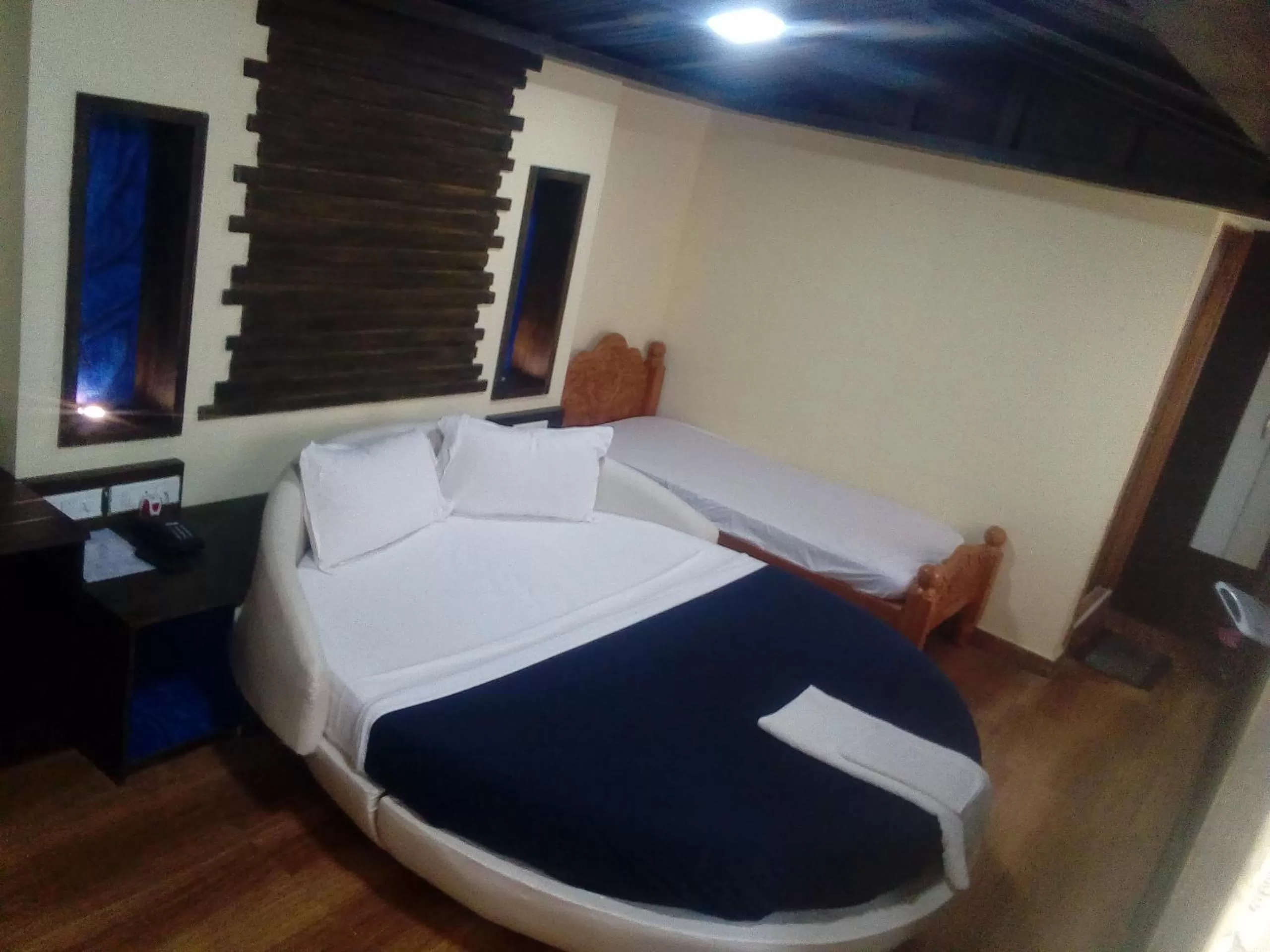 Bed in Hotel Anandhiram Heritage