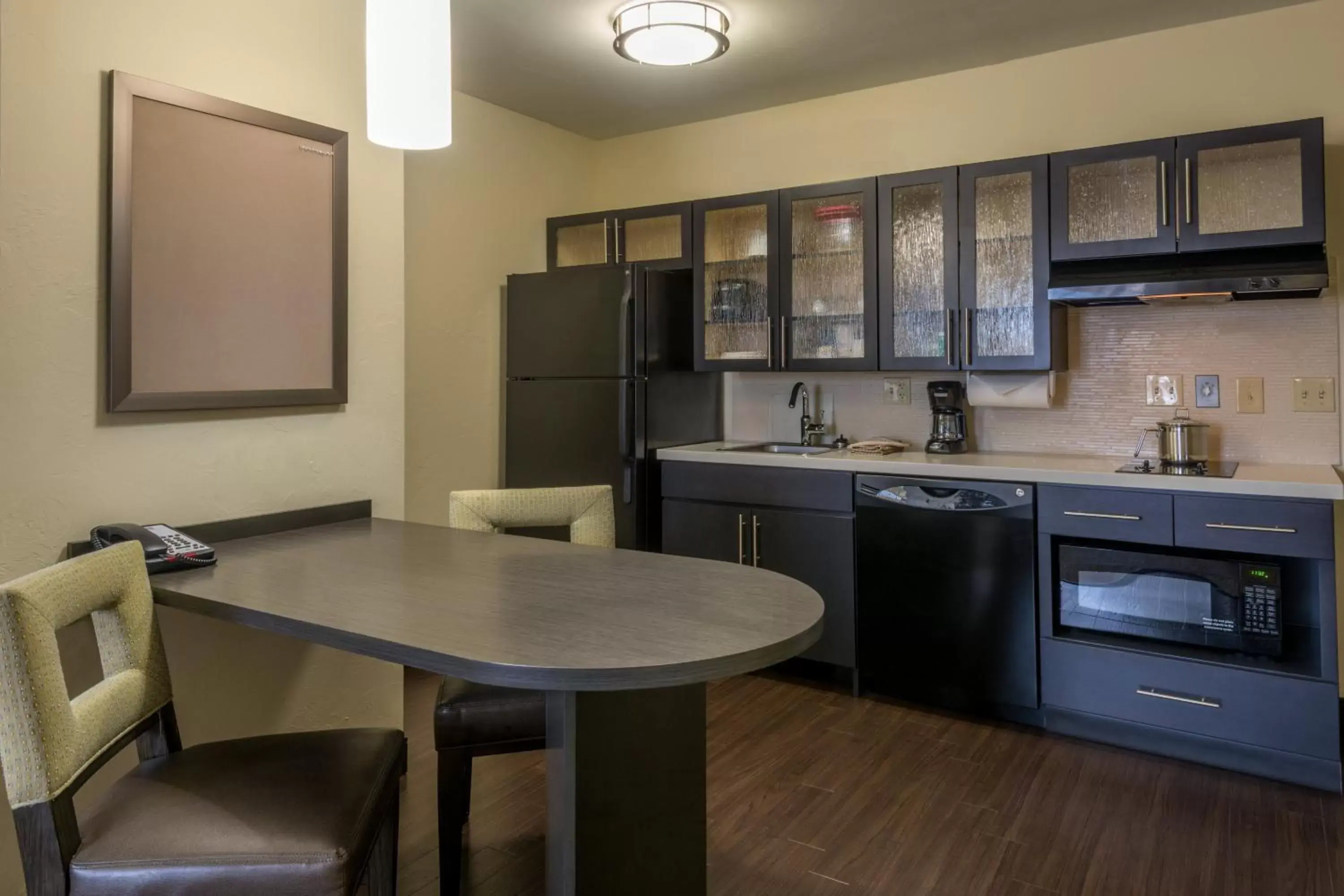 Bedroom, Kitchen/Kitchenette in Candlewood Suites Del City, an IHG Hotel