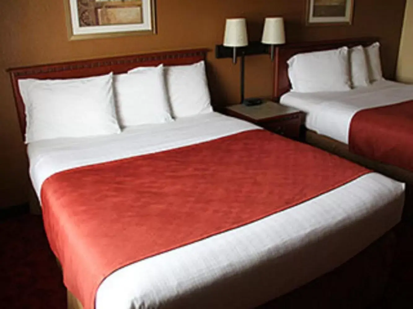 Bed in AmericInn by Wyndham West Bend