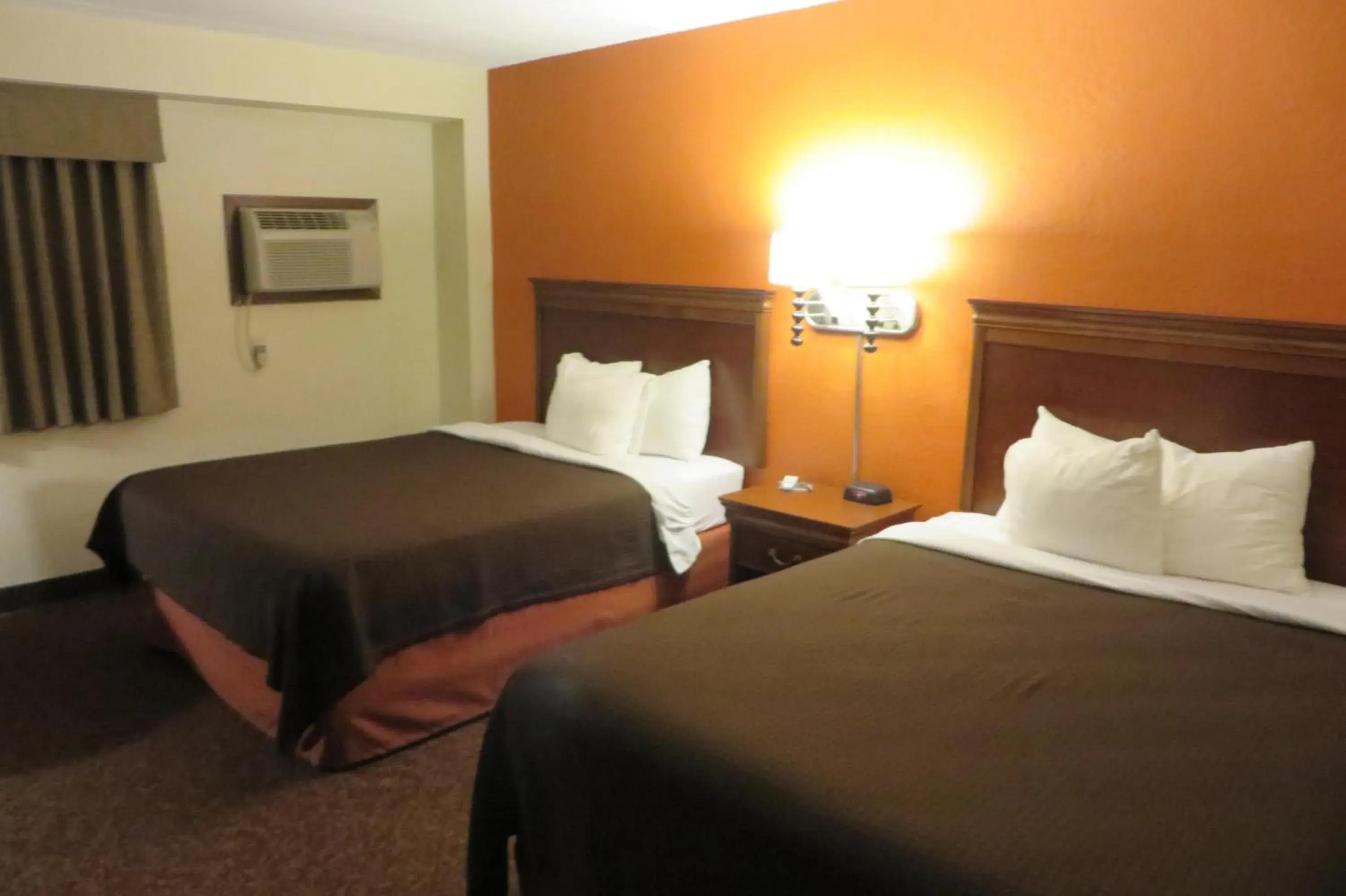 Bed in AmericInn by Wyndham Forest Lake