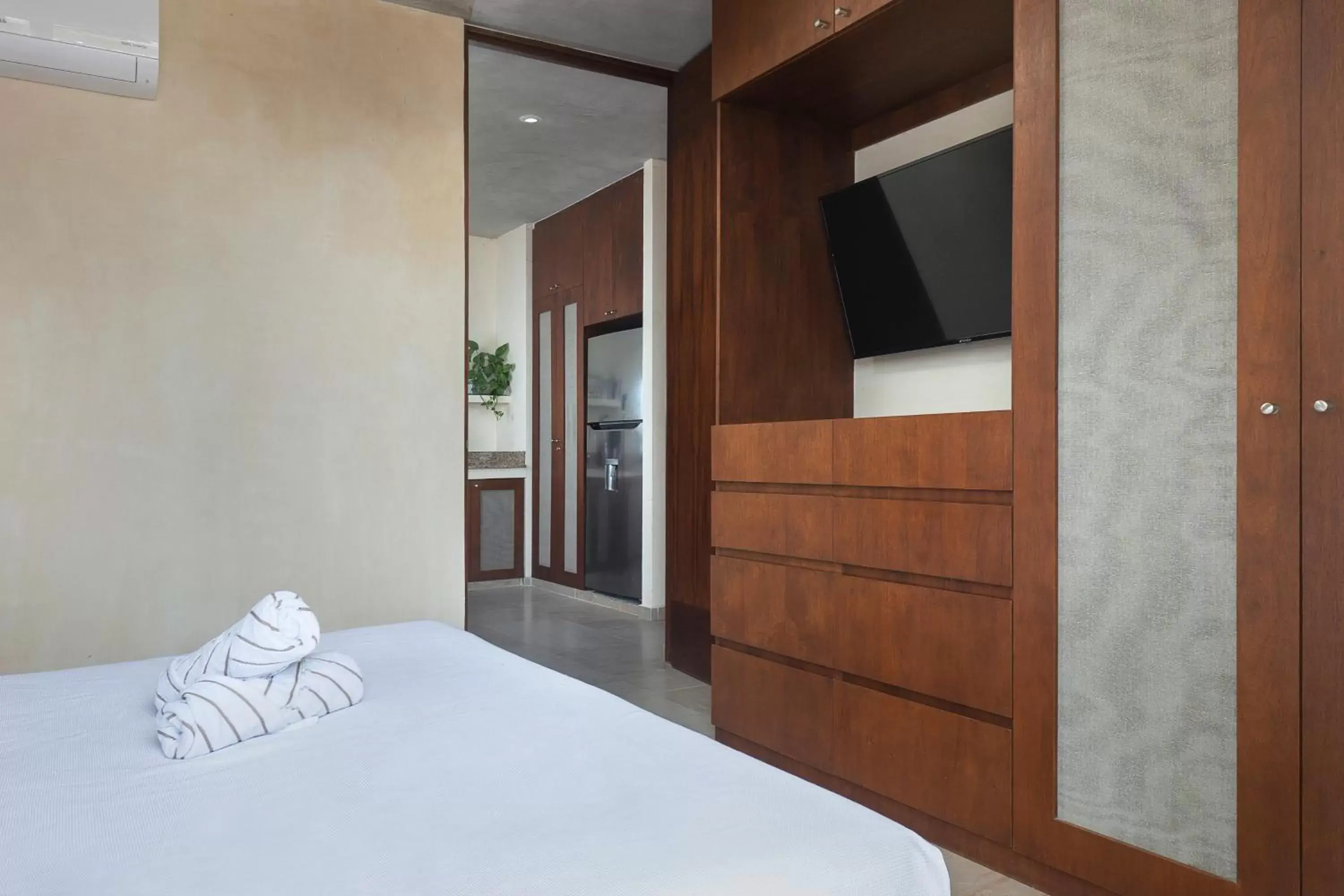 Bed, TV/Entertainment Center in ARUNA TULUM-Luxury Studios & Apartments