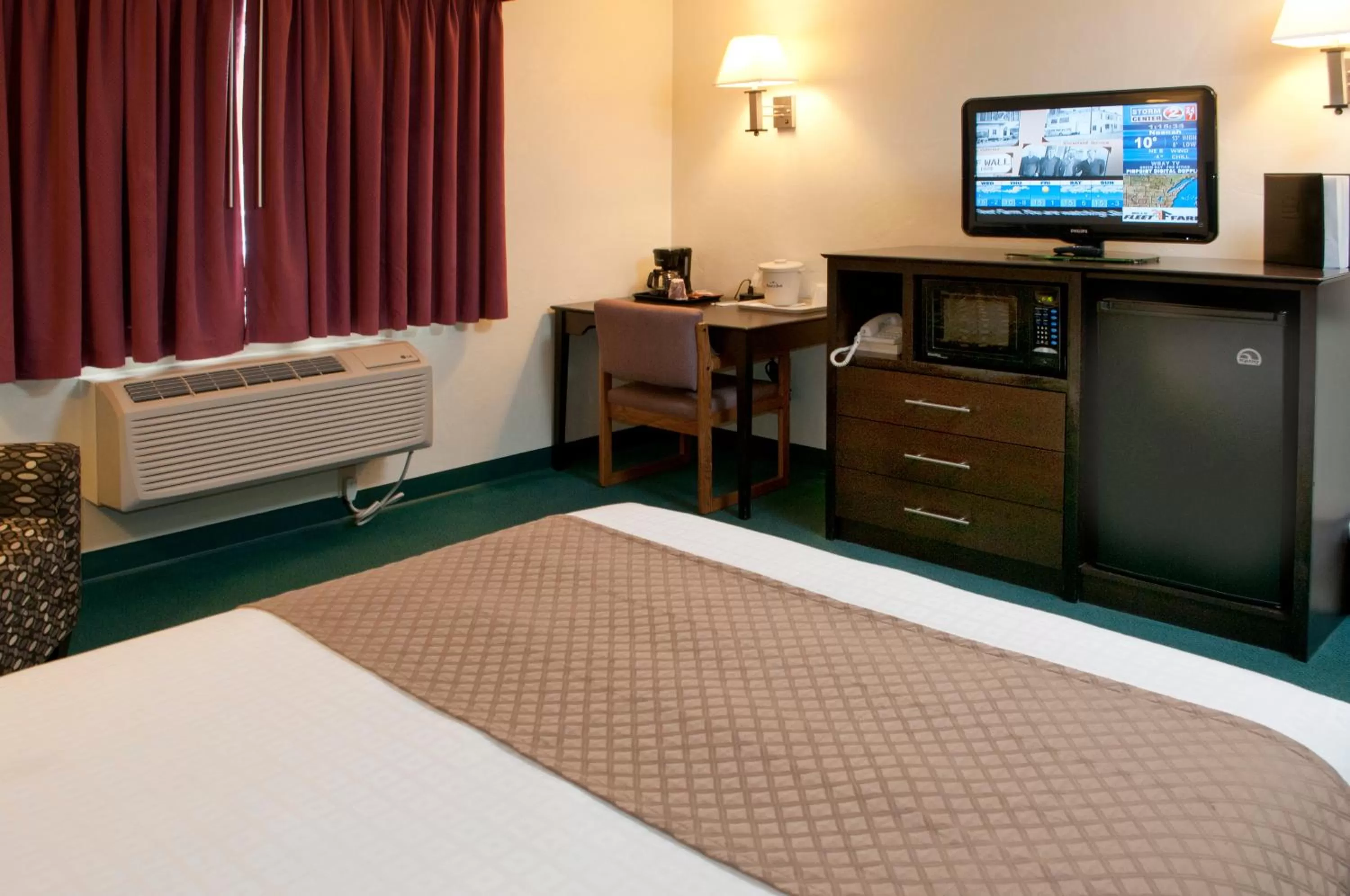 Decorative detail, Bed in AmericInn by Wyndham Green Bay West