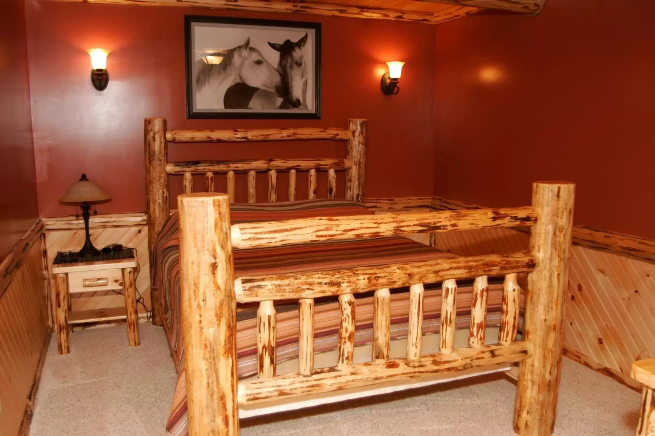 Bed in Sojourner's Lodge & Log Cabin Suites