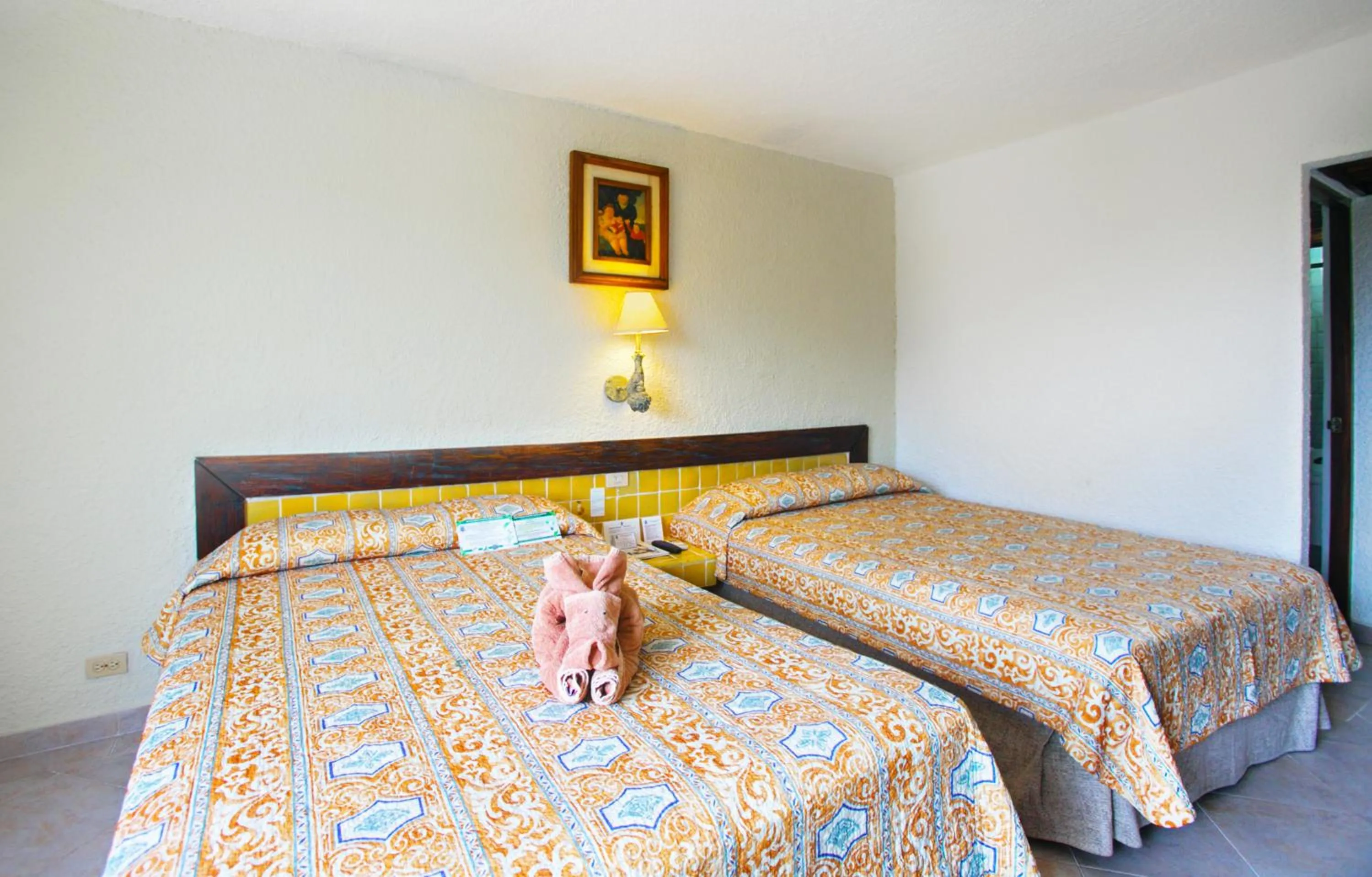 Bed in Casa del Mar Cozumel Hotel & Dive Resort with free access to an exclusive beach club