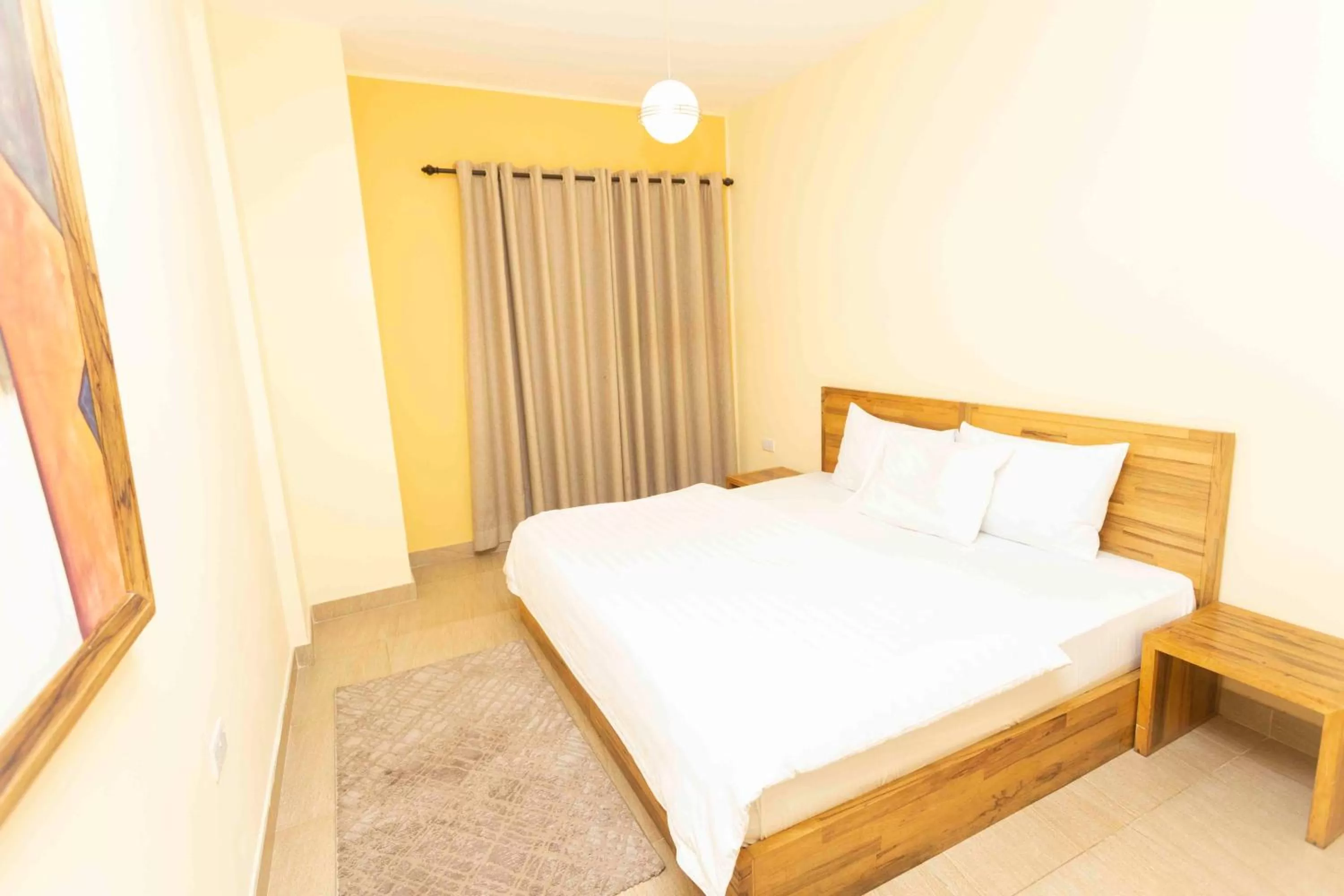 Bed in Roots Hotel Apartment