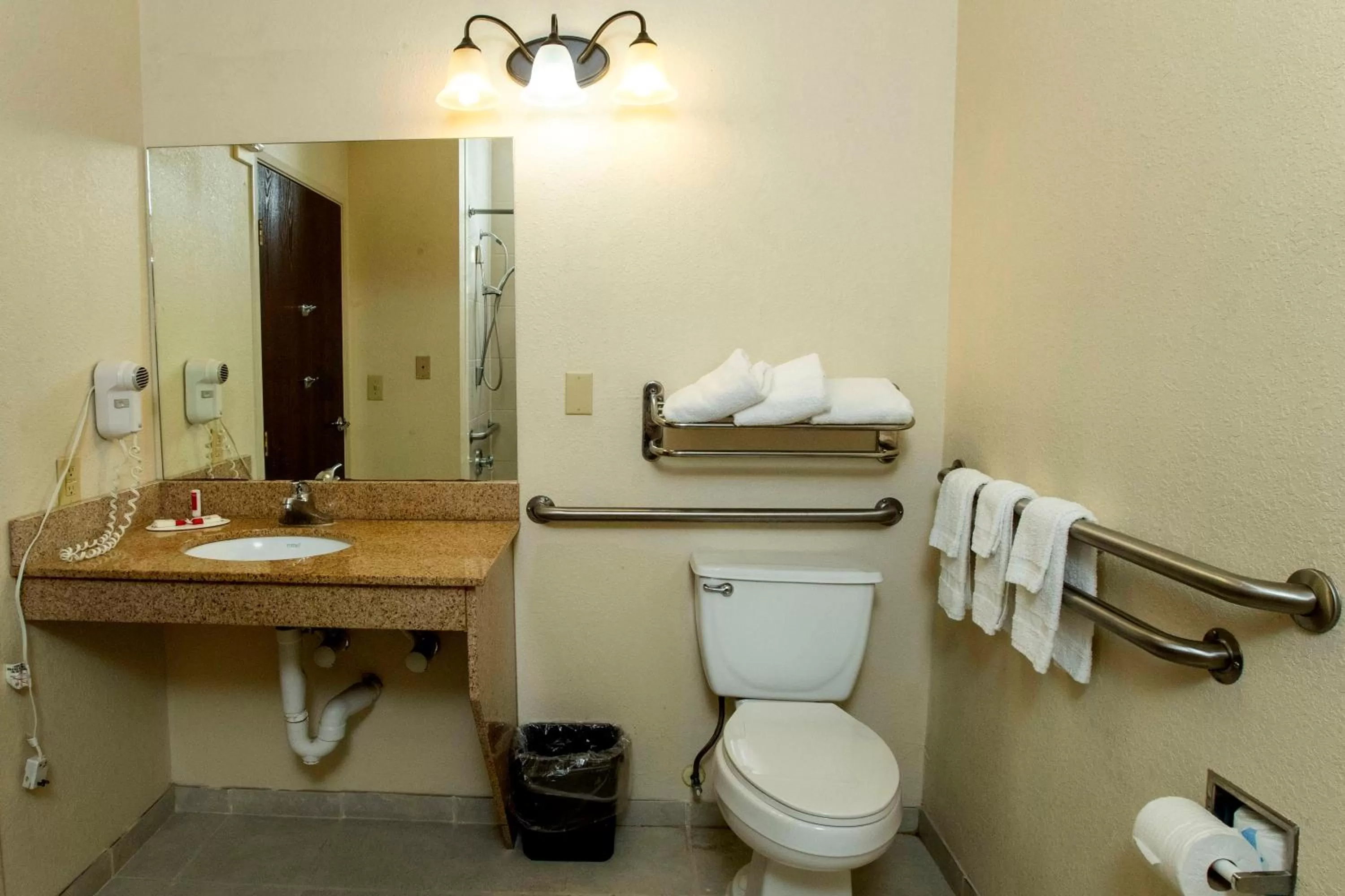 Toilet in Days Inn & Suites by Wyndham Houston North/Aldine