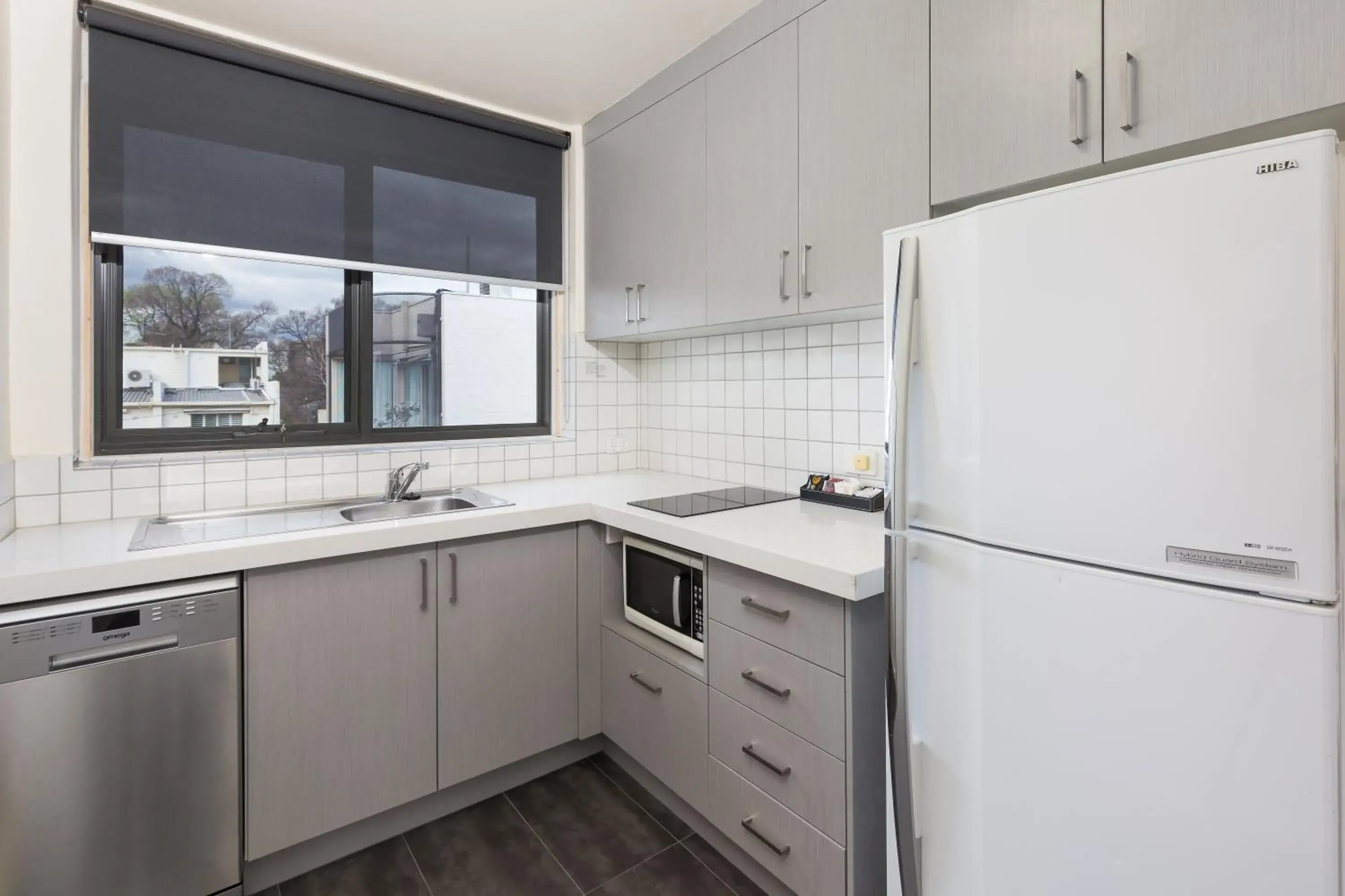 Kitchen or kitchenette in City Edge East Melbourne Apartment Hotel