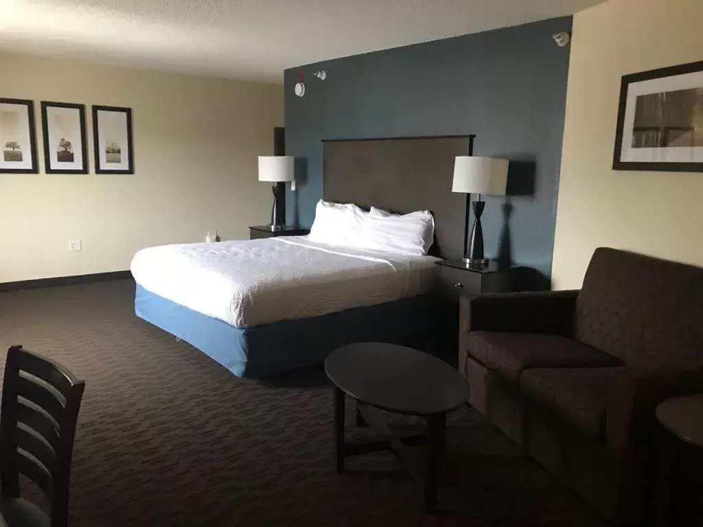 Bed in AmericInn by Wyndham Hotel and Suites Long Lake