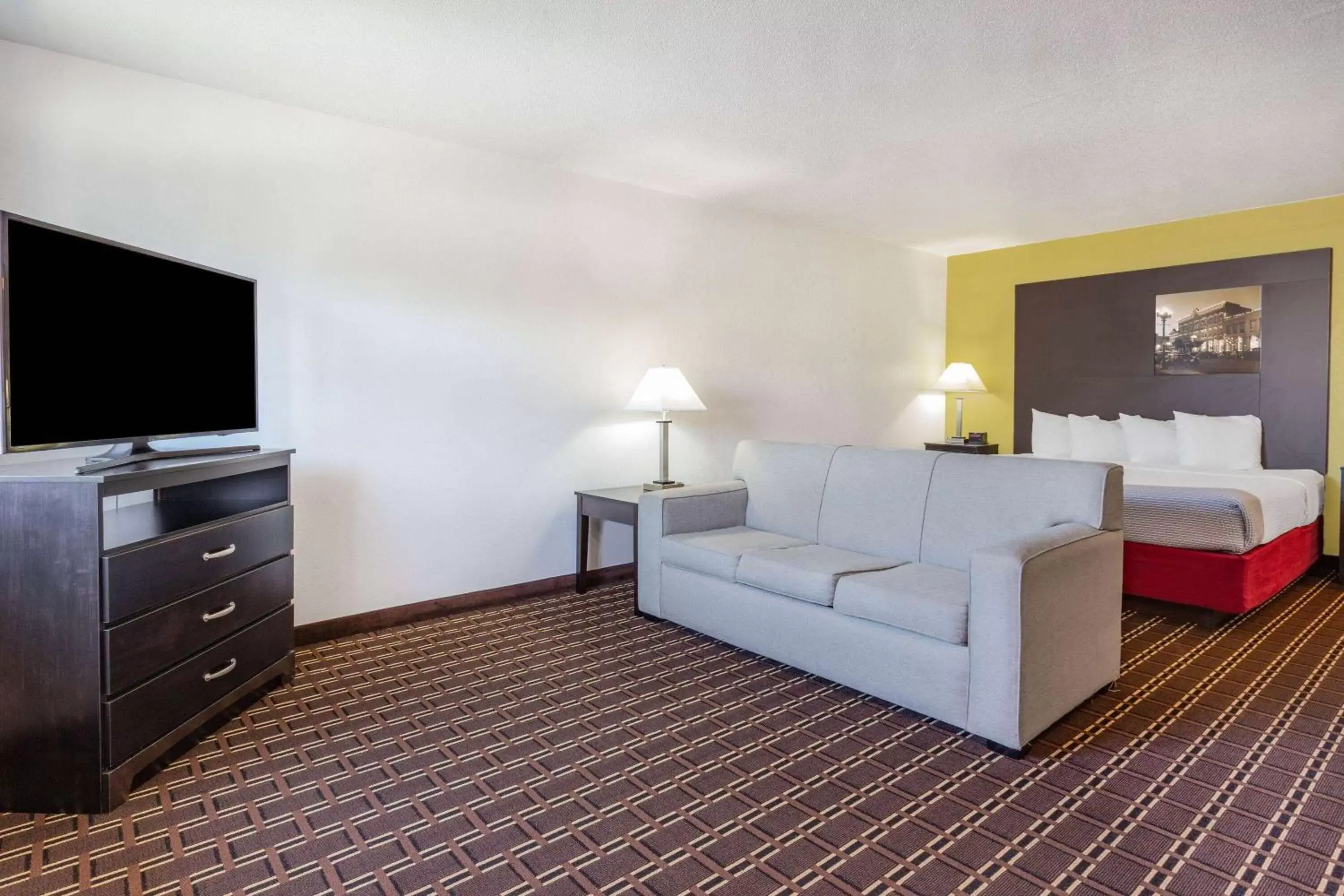 Bed, Seating Area in Super 8 by Wyndham La Crosse
