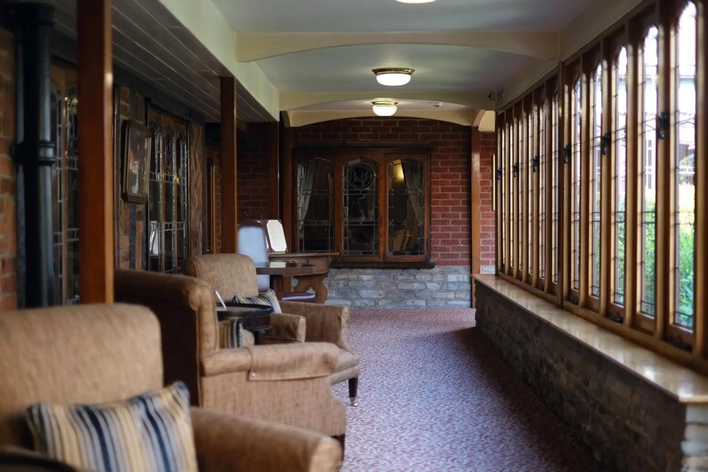 Communal lounge/ TV room in Macdonald Alveston Manor Hotel