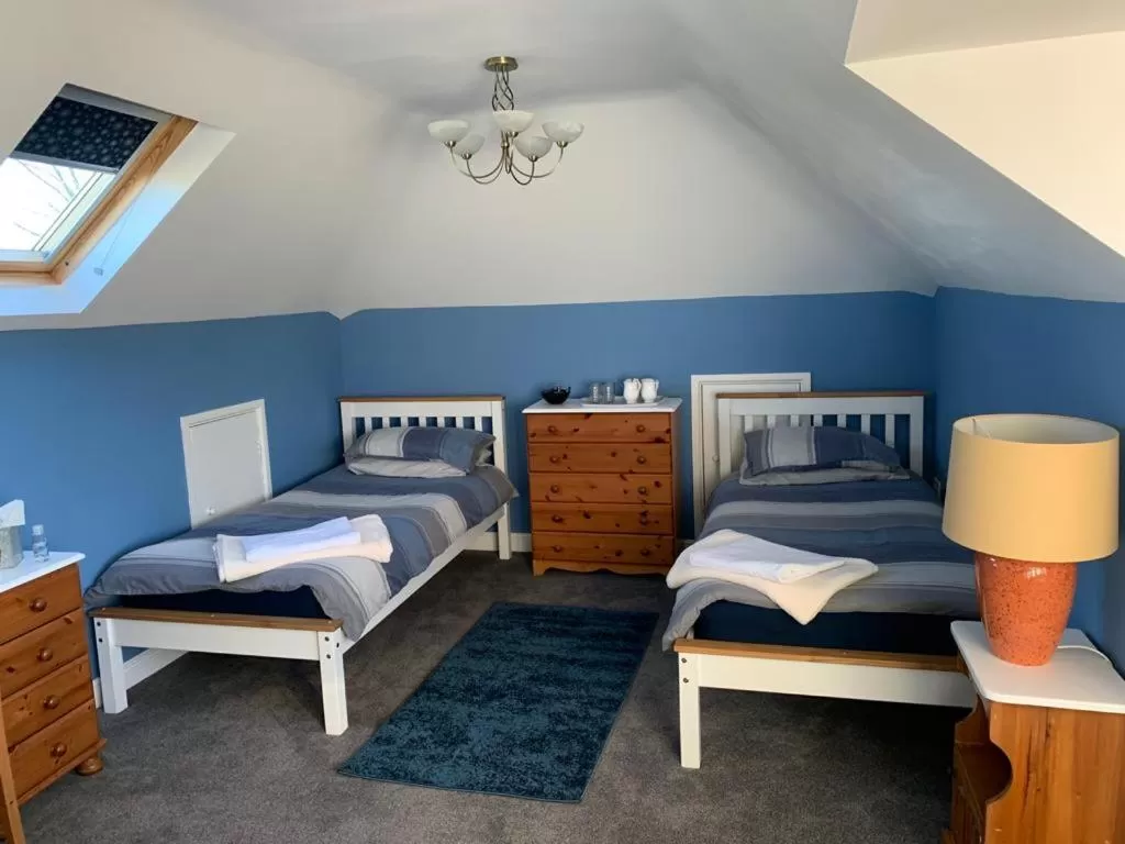 Bed in TRETHEWEY GUEST HOUSE