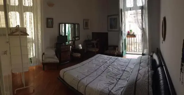 Photo of the whole room, Bed in In Via Roma