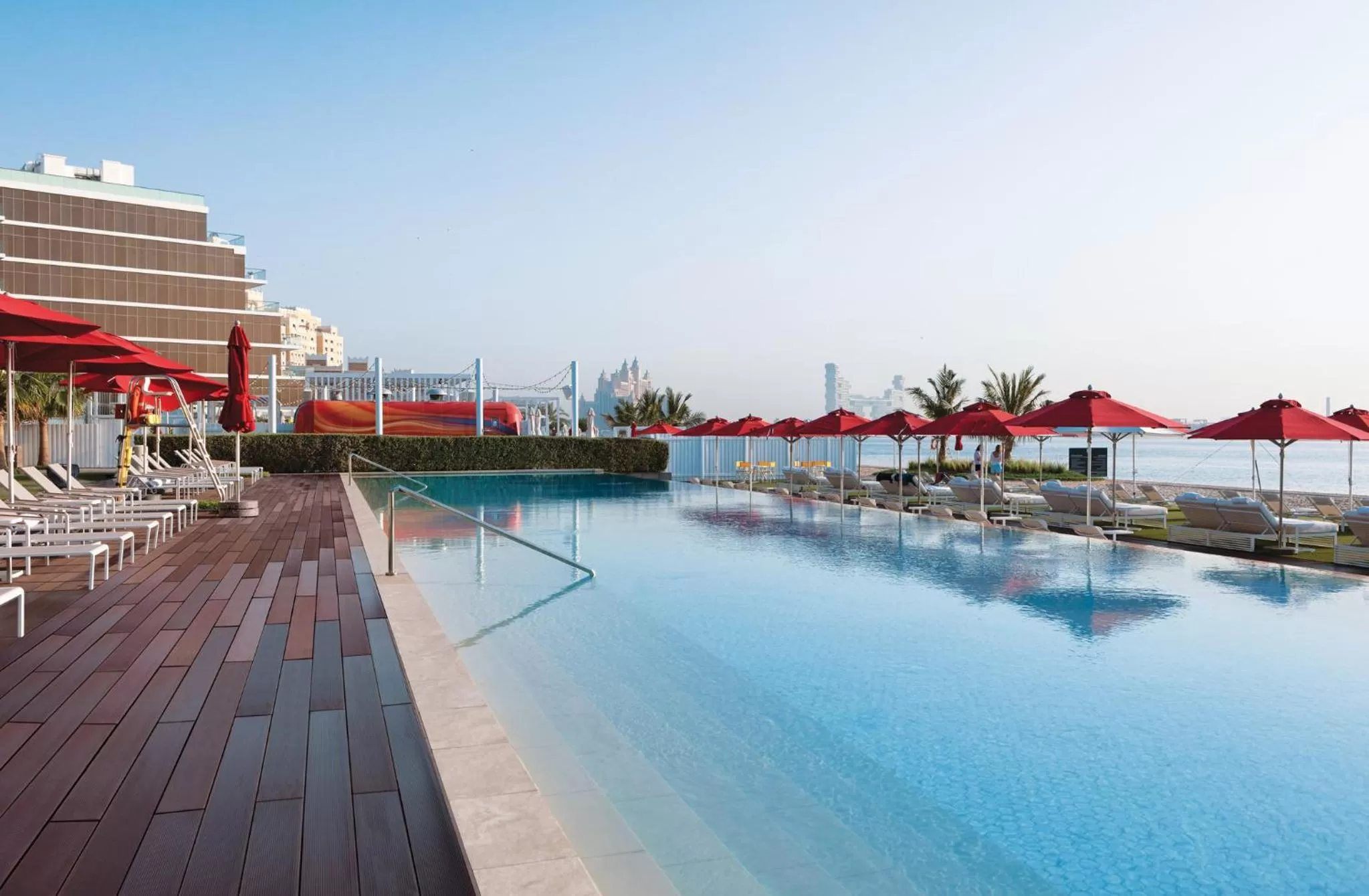 Swimming pool in Th8 Palm Dubai Beach Resort Vignette Collection, an IHG hotel