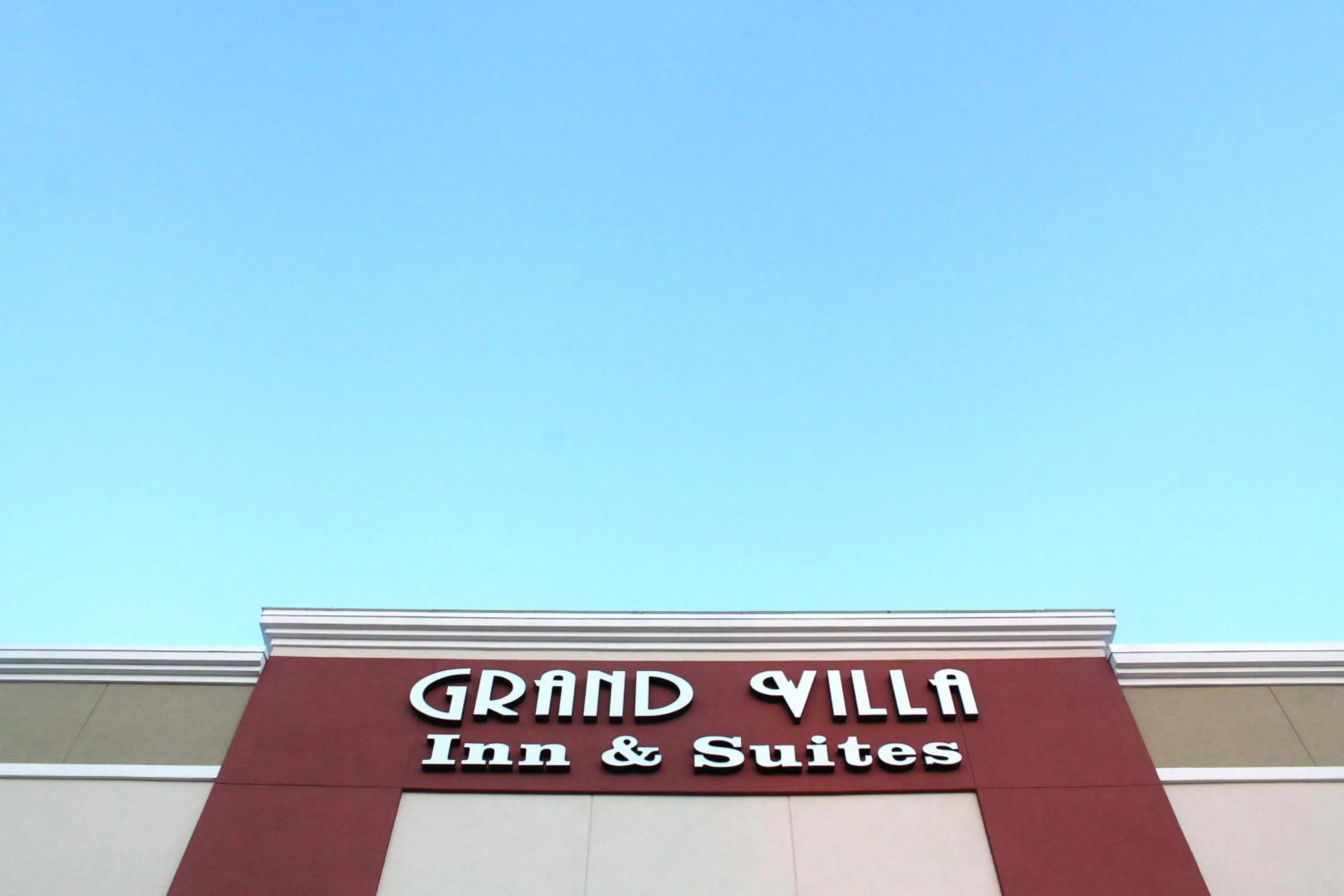 Property logo or sign in Grand Villa Inn and Suites Westchase/Chinatown