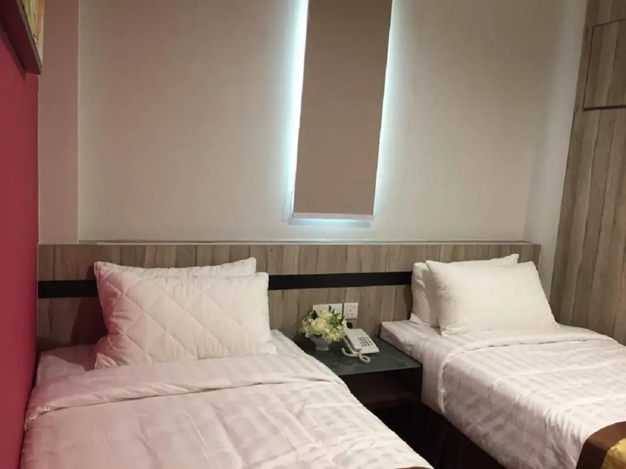 Bed in Meriton Inn Hotel