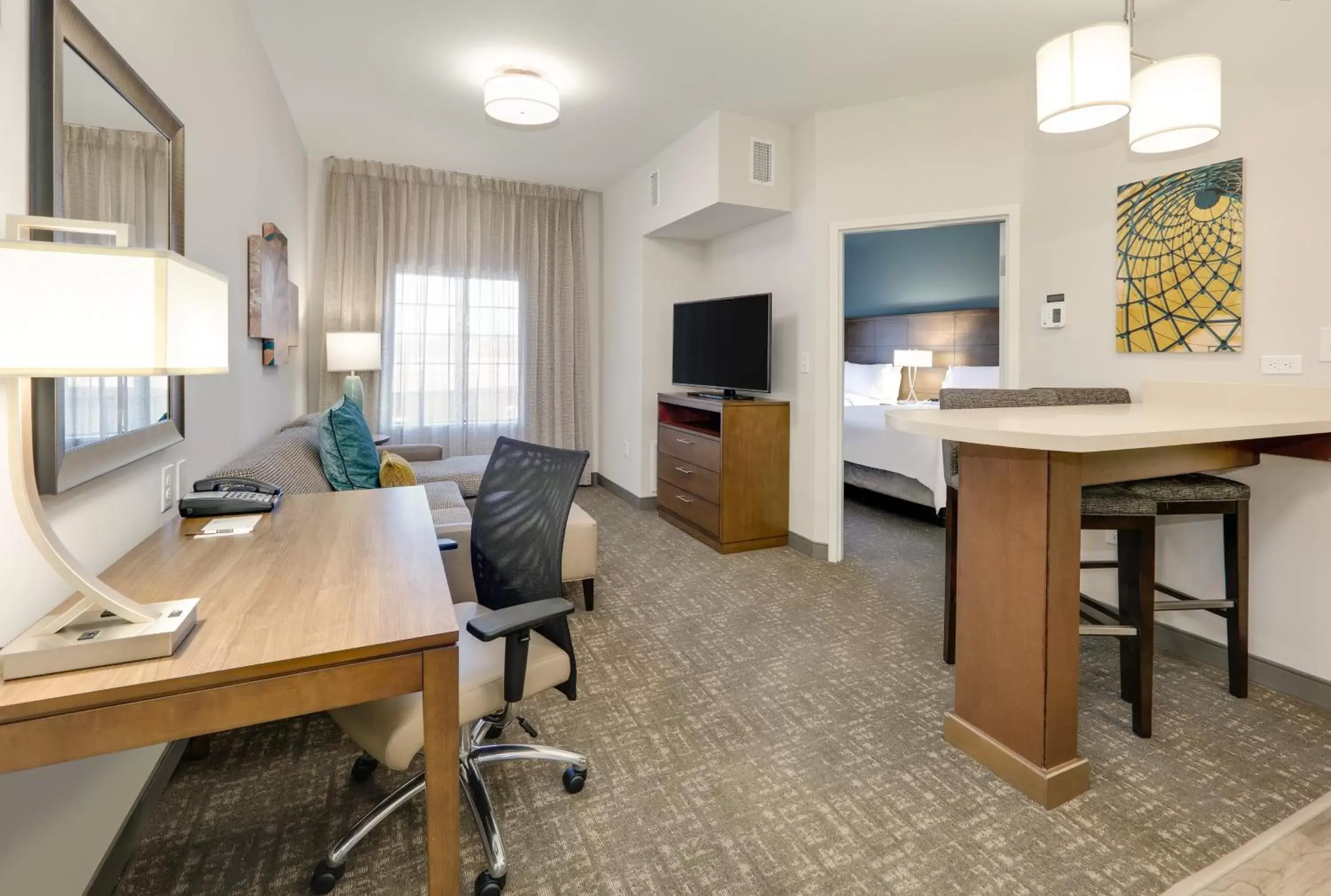 Bedroom, Seating Area in Staybridge Suites - Oklahoma City - Downtown, an IHG Hotel