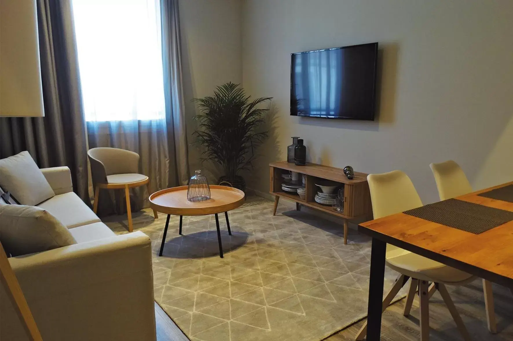 TV and multimedia, Seating Area in Bilbao City Center by abba Suites