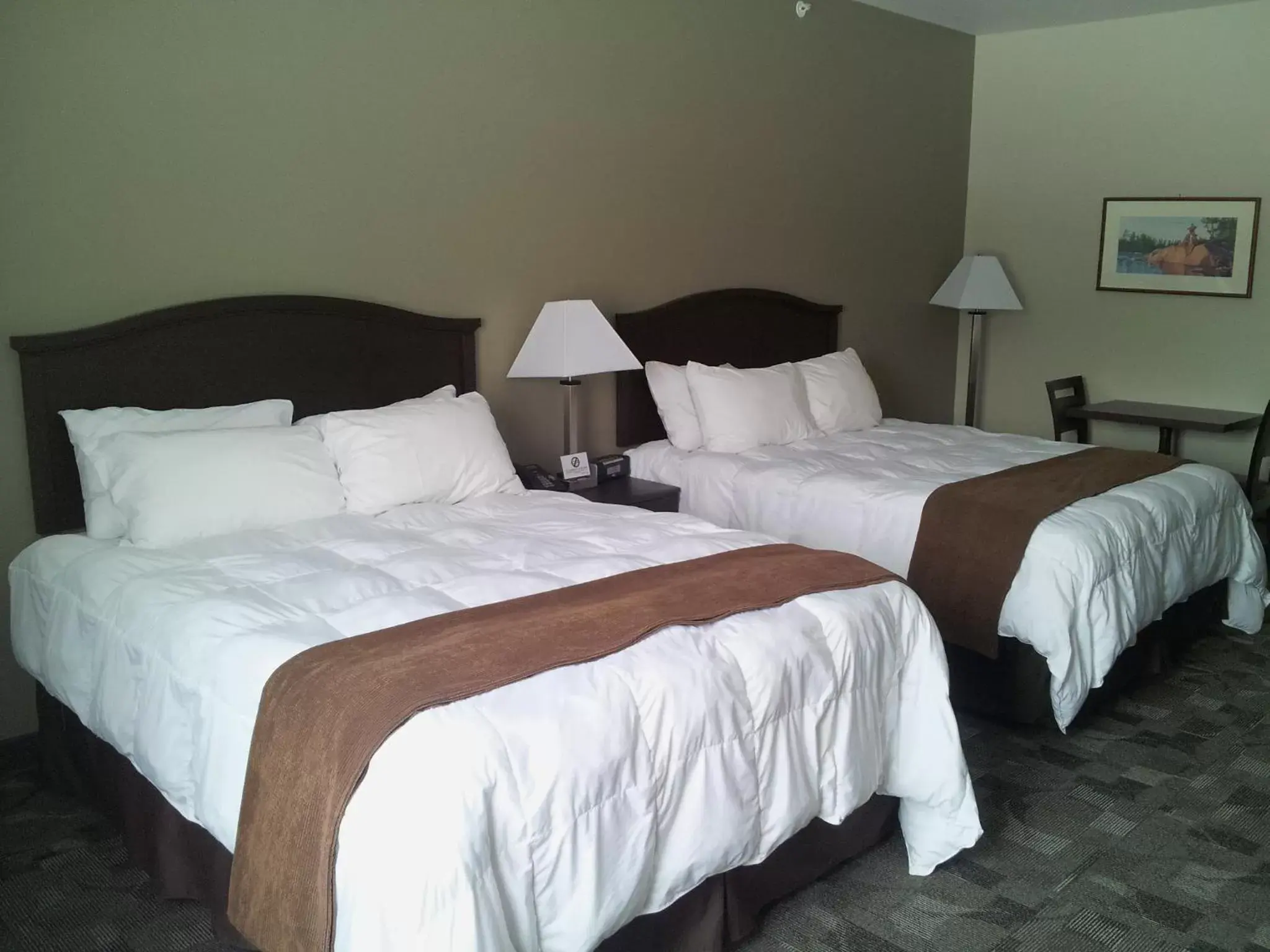 Bed in Midland Inn & Suites
