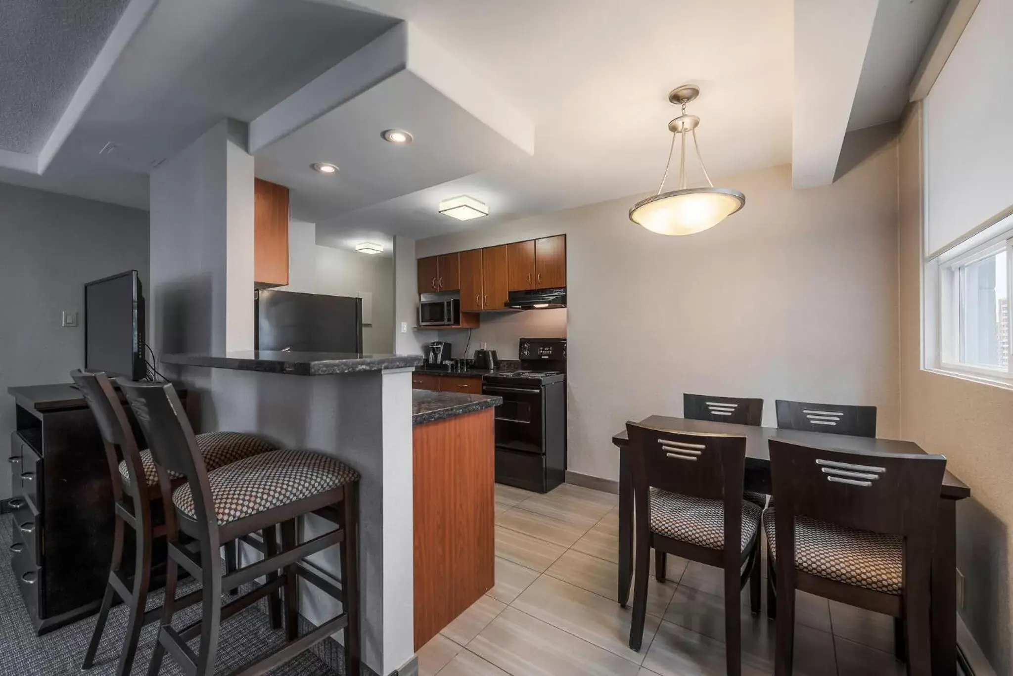 Kitchen or kitchenette in Coast Calgary Downtown Hotel & Suites by APA