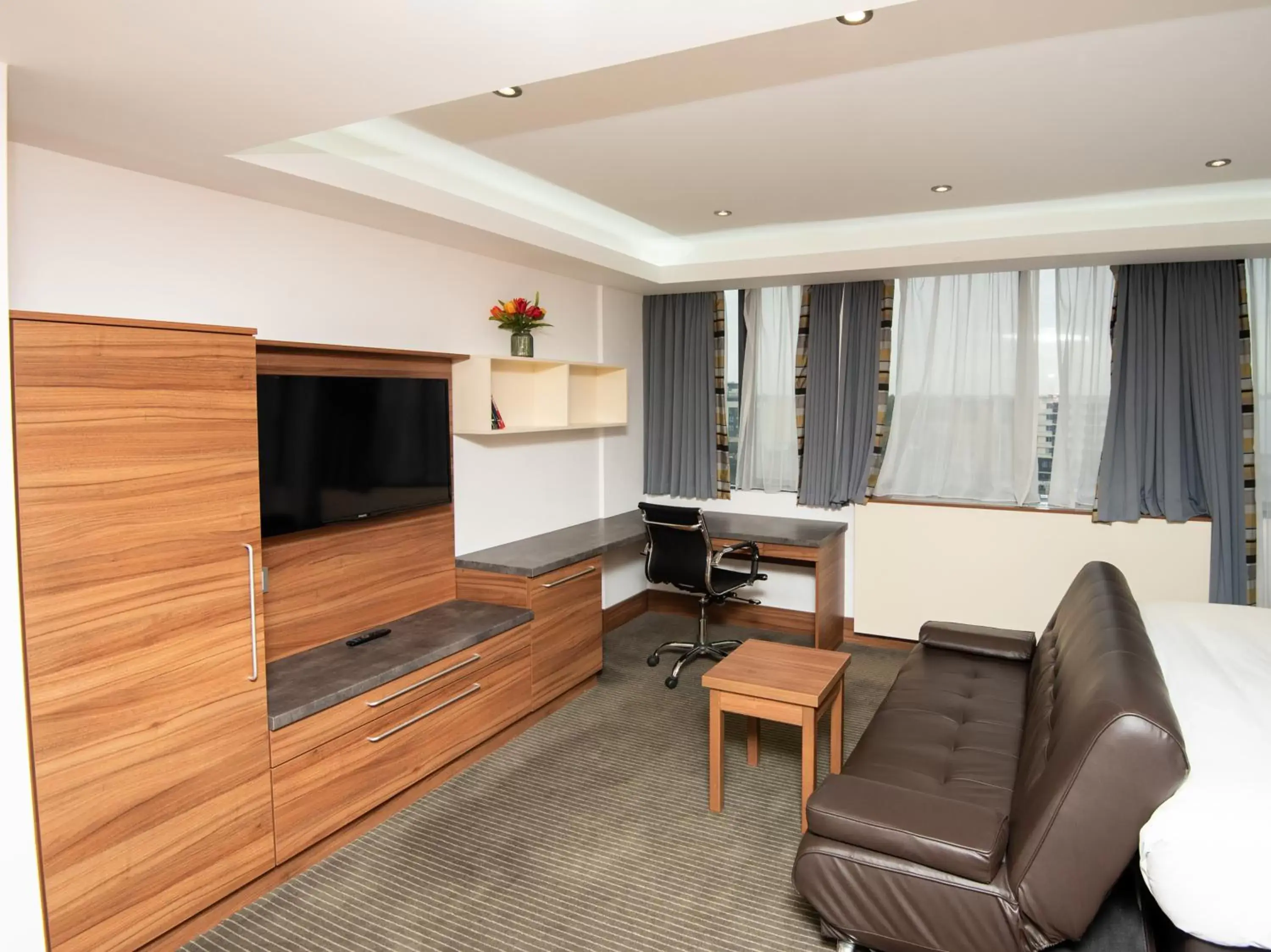 Seating area, TV/Entertainment Center in Livin' Serviced Apartments