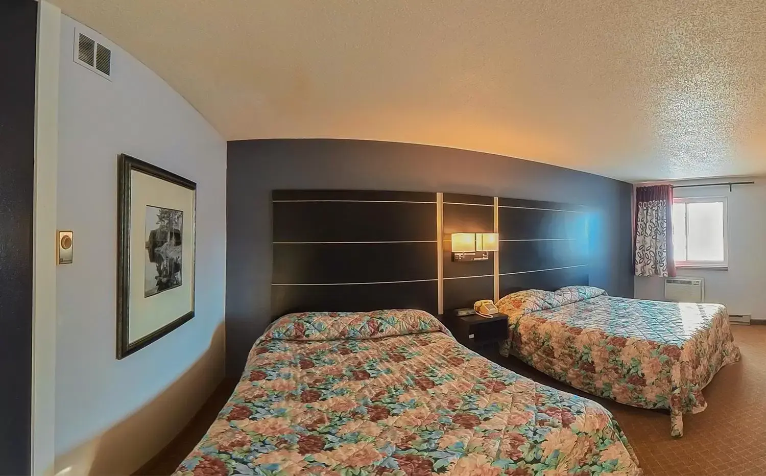 Bed in Coratel Inn & Suites by Jasper Hastings