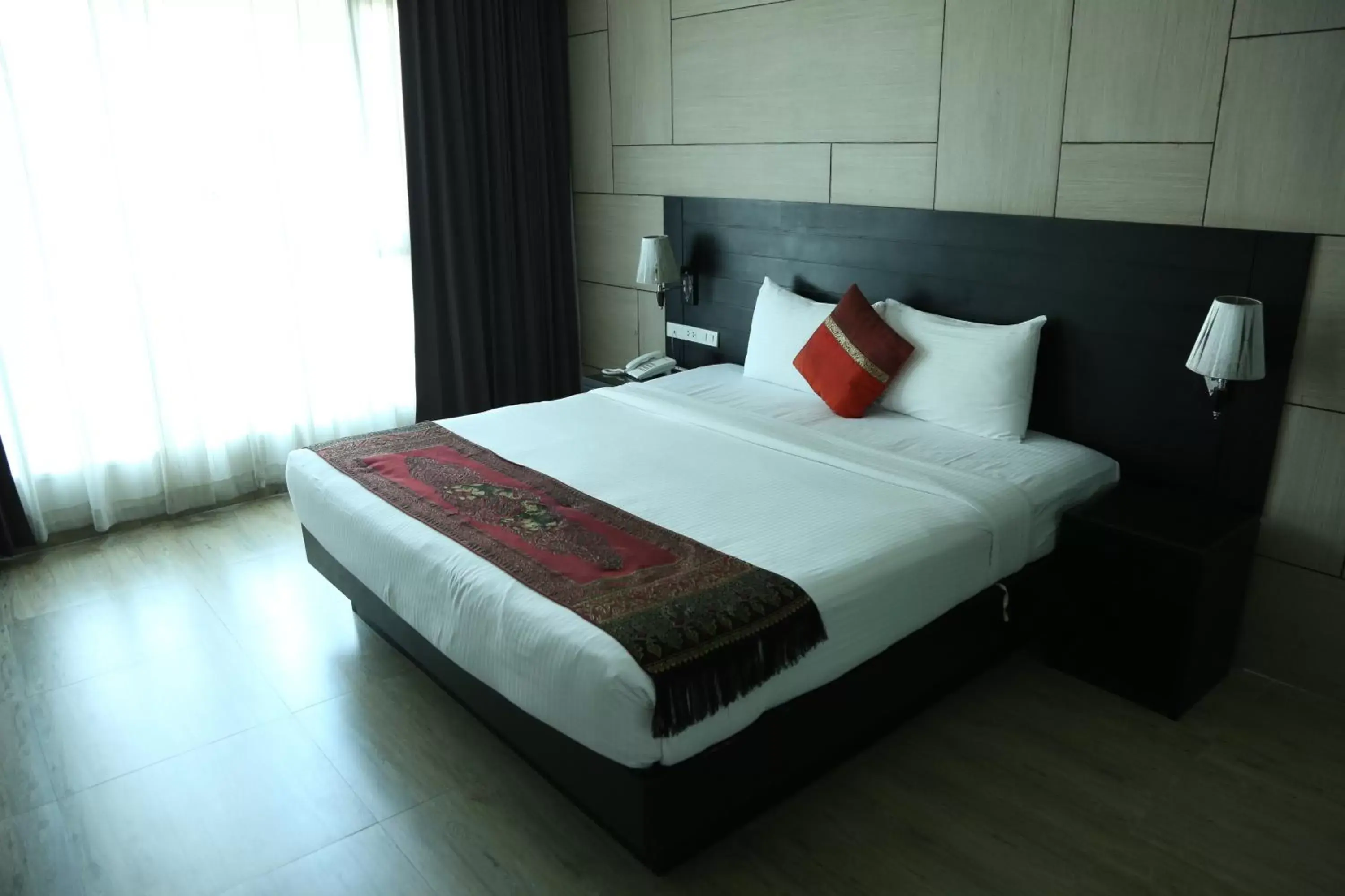 Bed in Boss Suites Nana Hotel