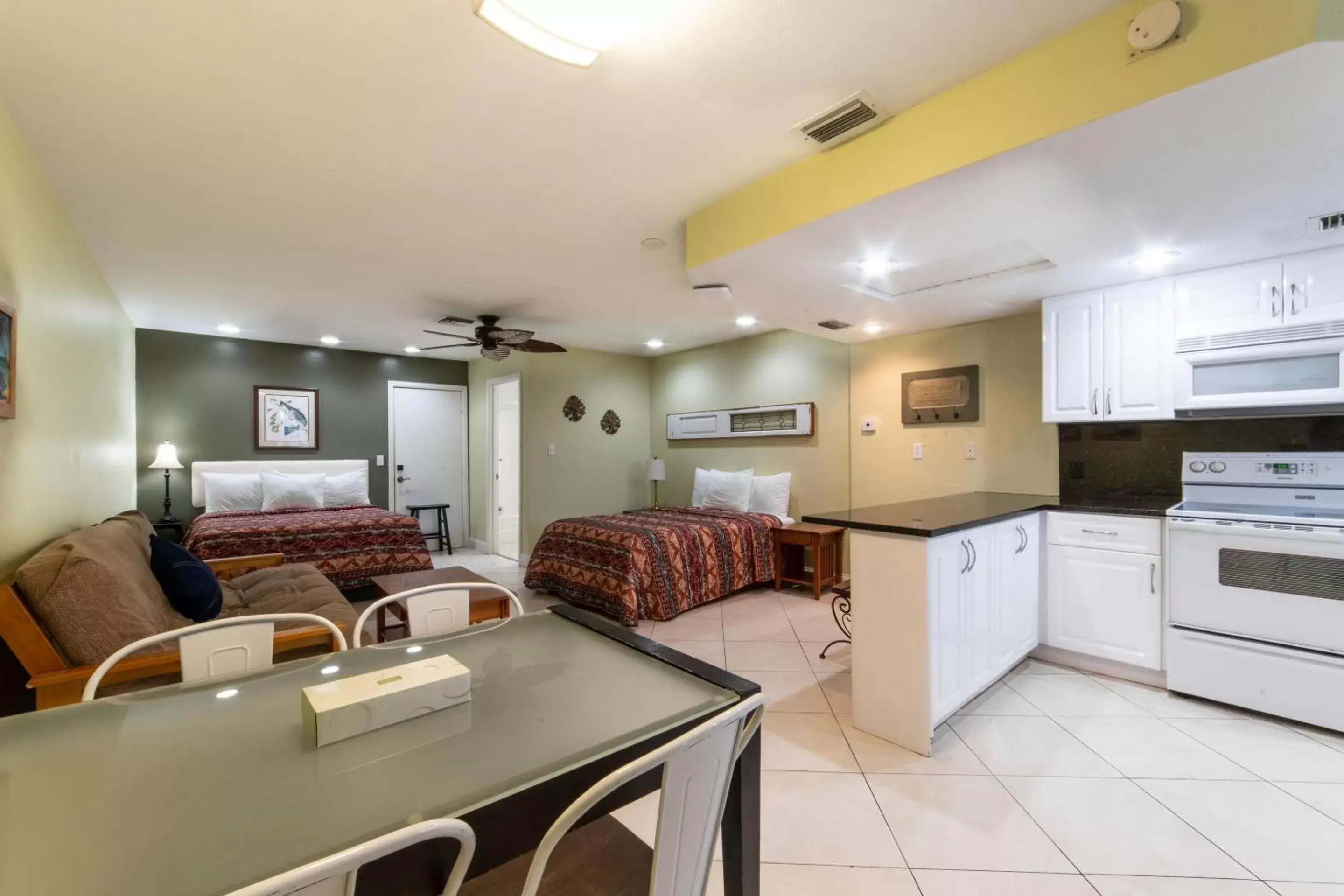 Bed, Kitchen/Kitchenette in Captain's Table Hotel by Everglades Adventures