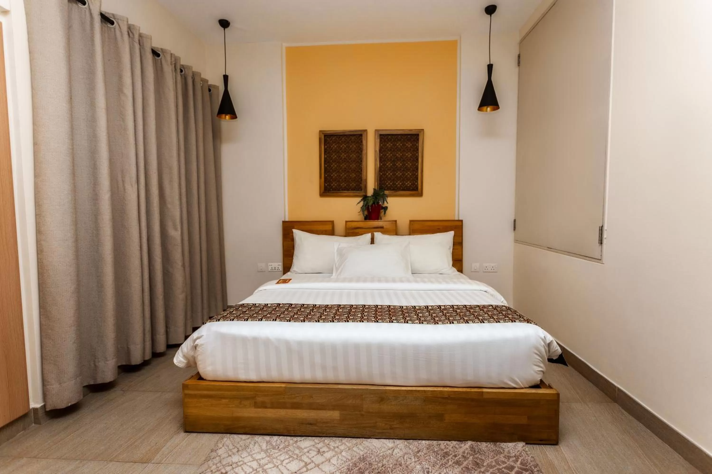 Bed in Roots Hotel Apartment