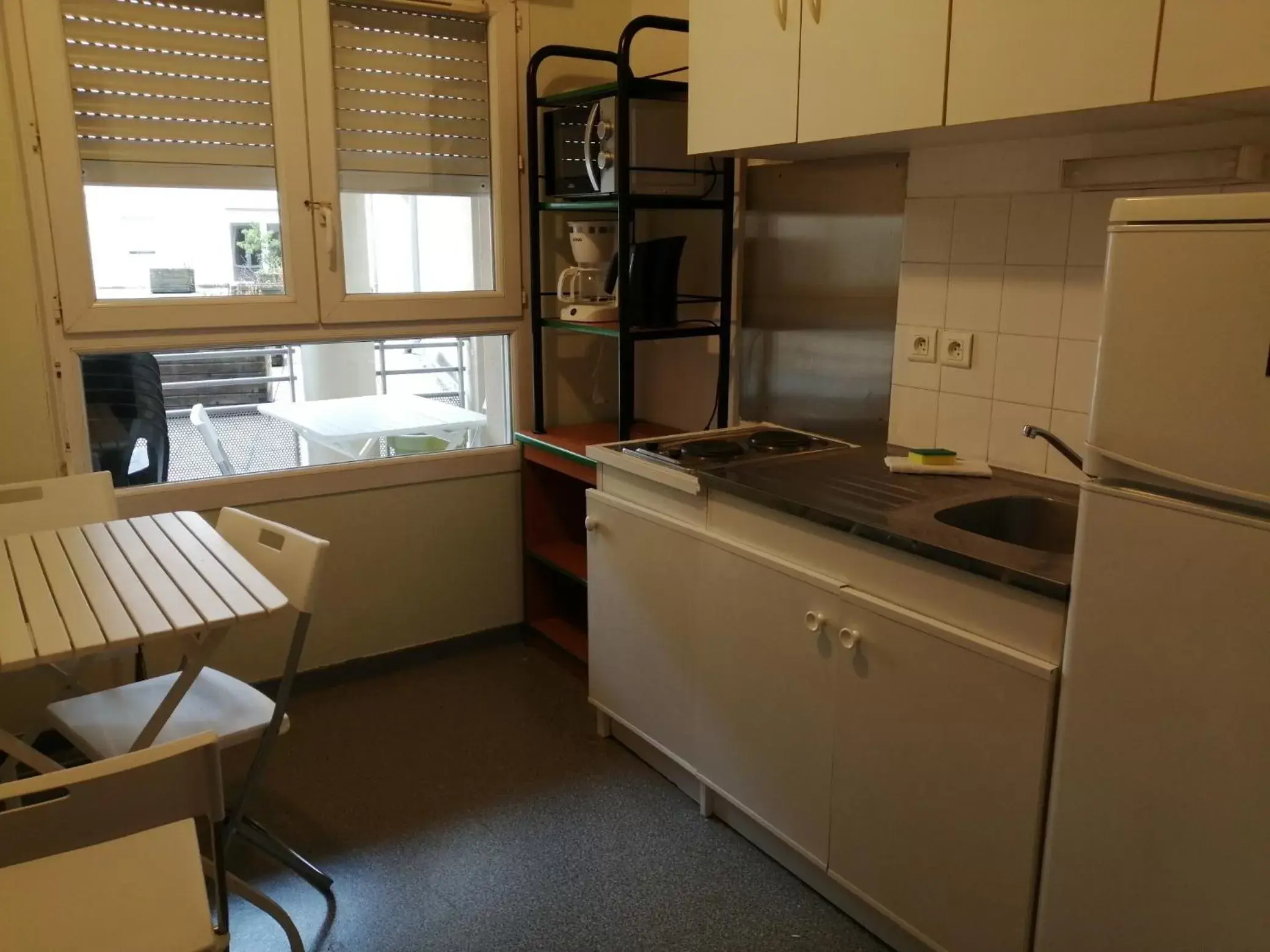 Kitchen or kitchenette in Hôtel et Résidence Les Lauréades Clermont-Ferrand Centre Jaude