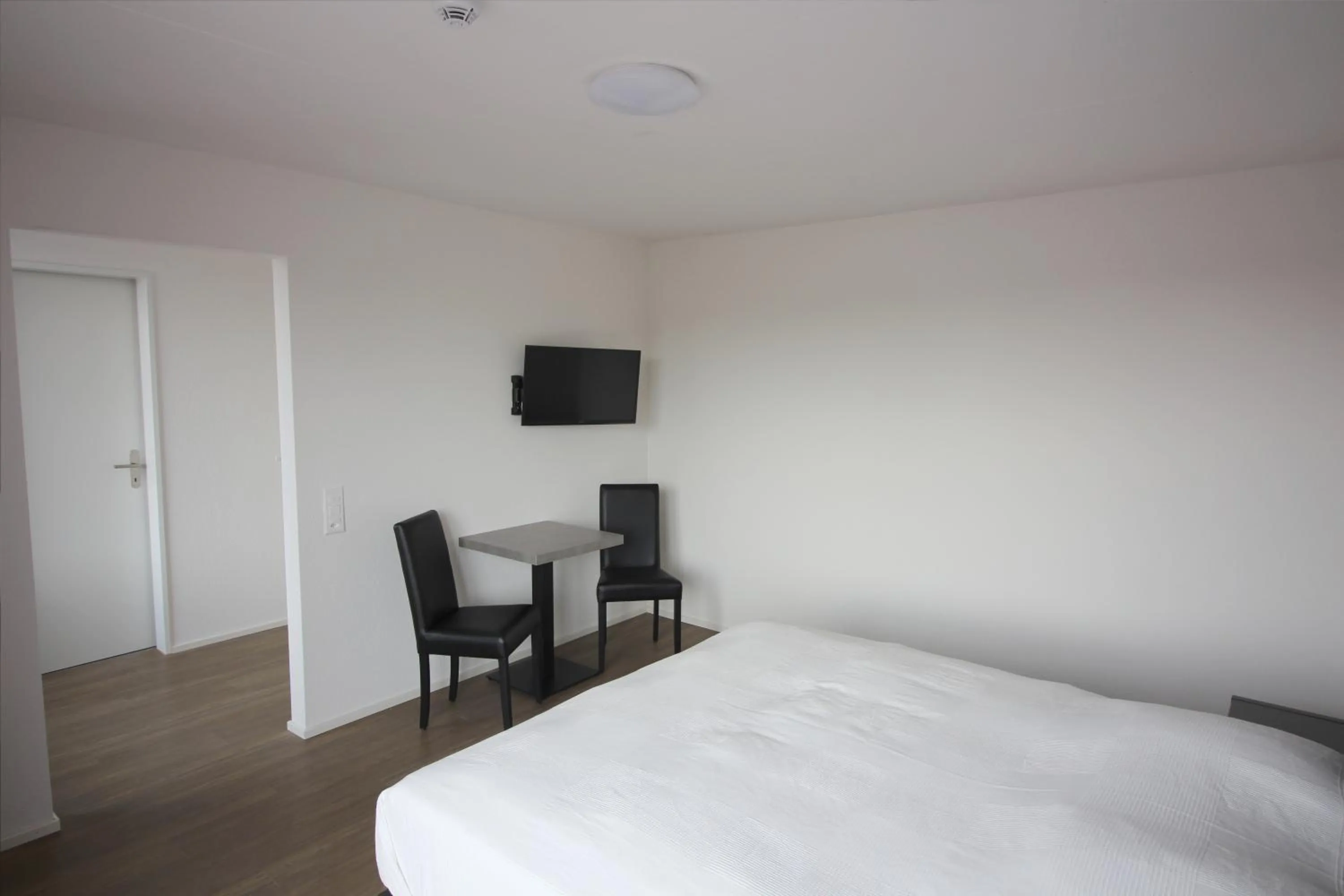 Seating area, Bed in Swiss Star Zurich Airport - Self Check-In