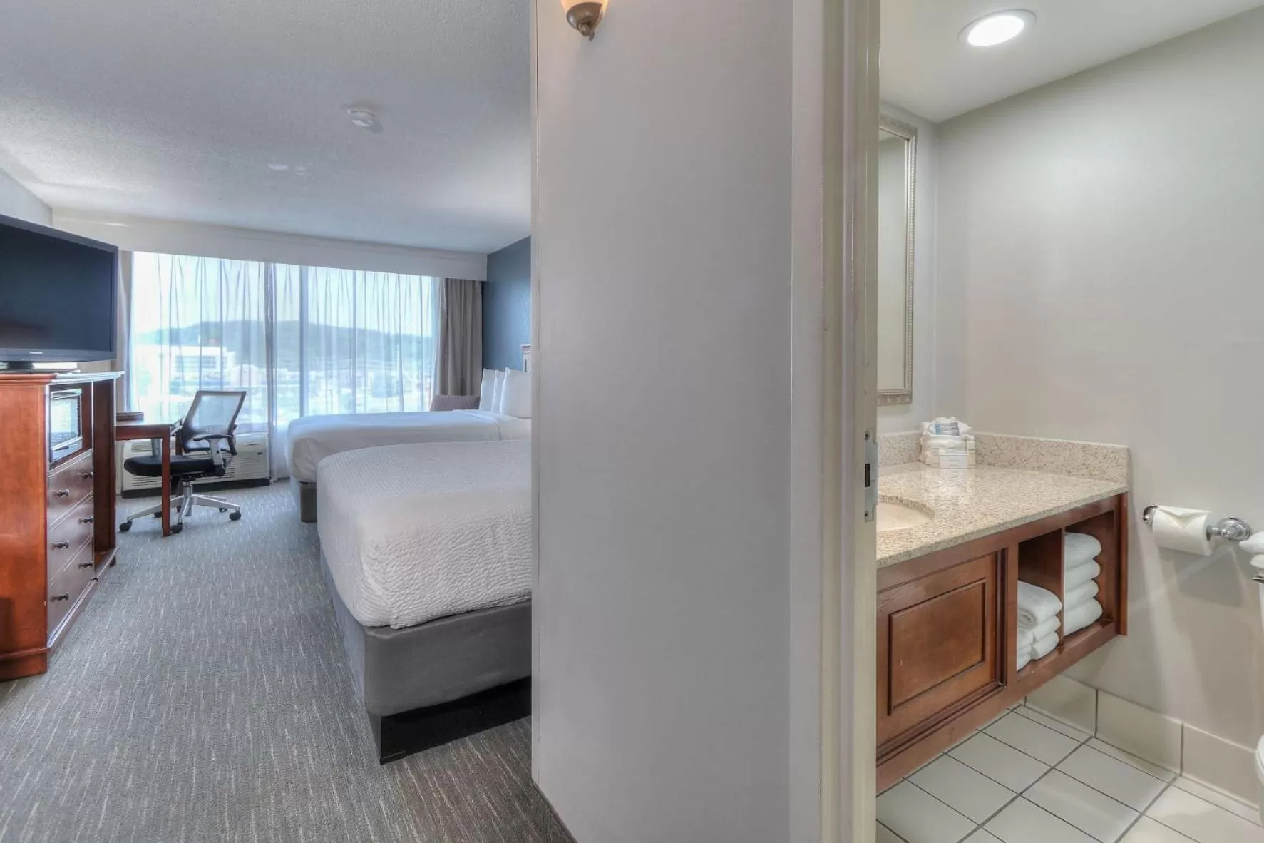 Bed in The Ramsey Hotel and Convention Center