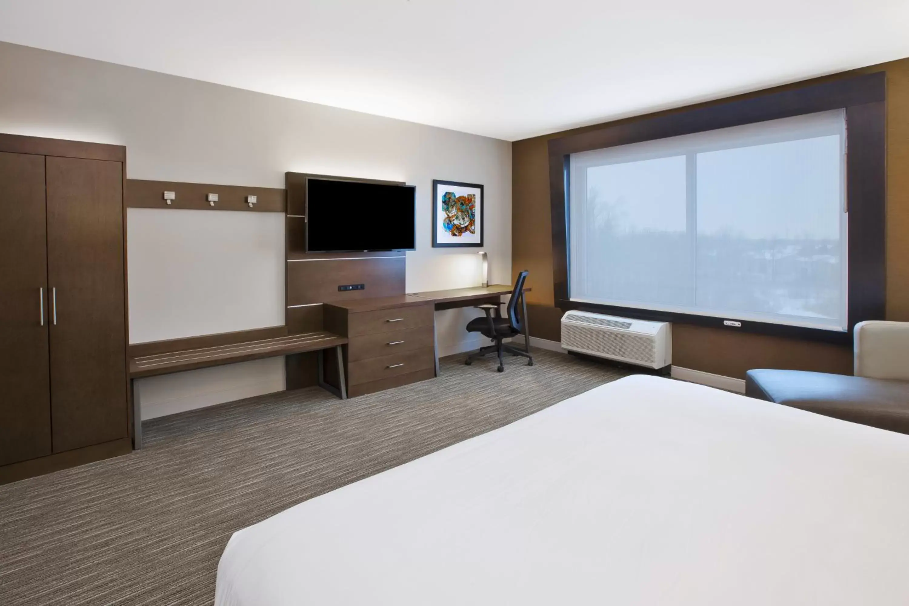 Photo of the whole room, TV/Entertainment Center in Holiday Inn Express & Suites - Okemos - University Area, an IHG Hotel