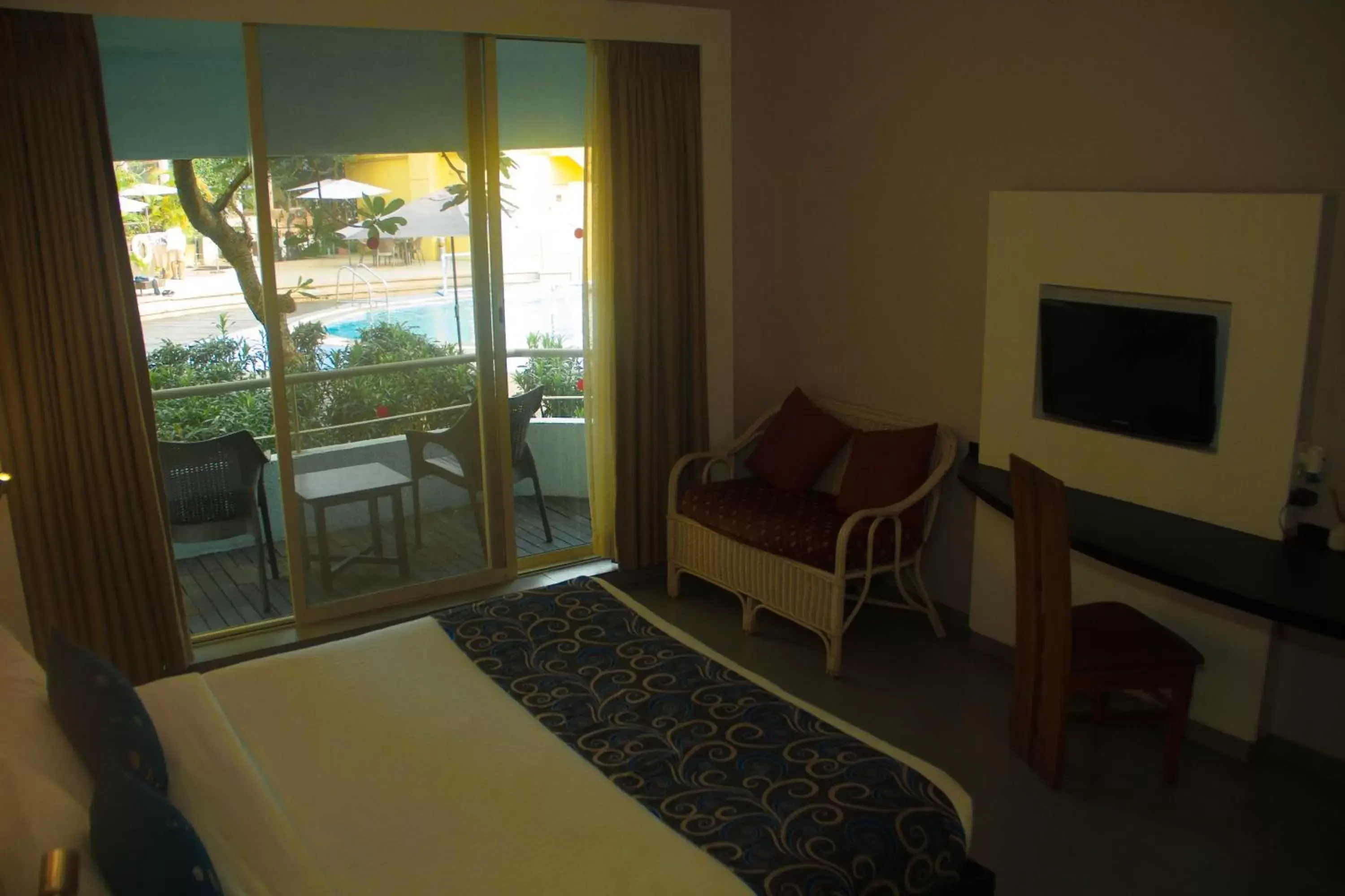 Pool view, TV/Entertainment Center in Whispering Palms Beach Resort