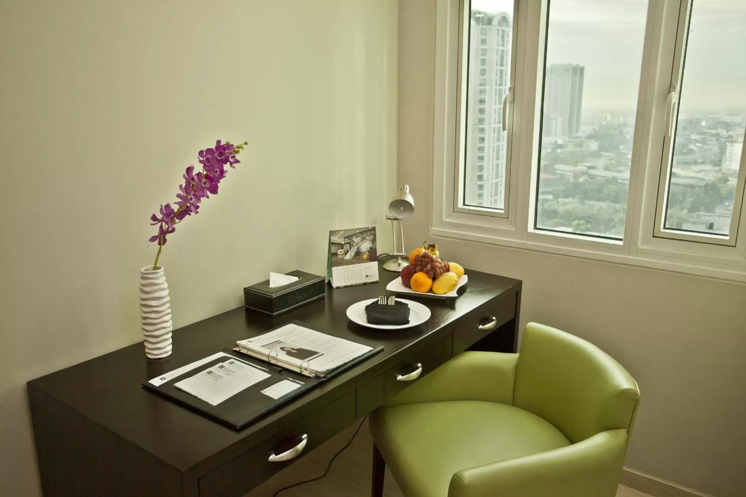 Seating area in The Exchange Regency Residence Hotel Managed by HII