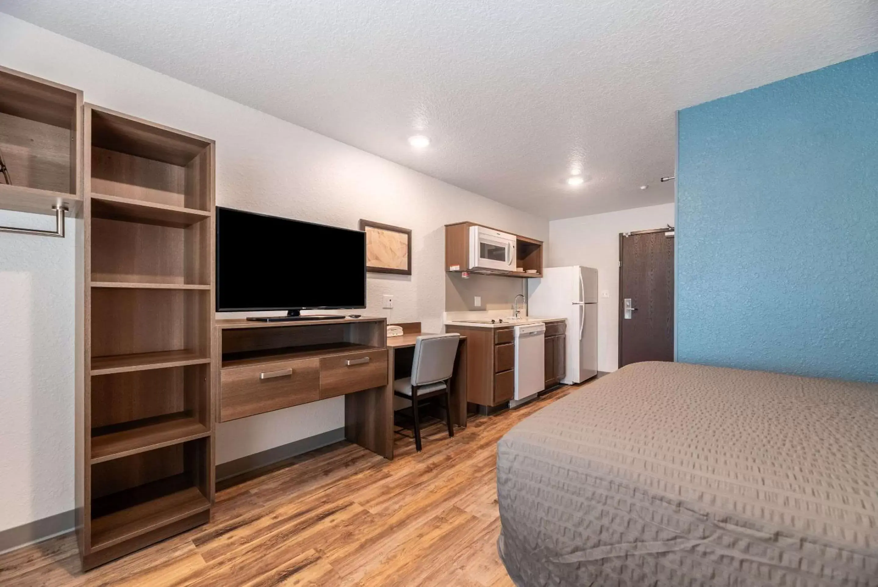 Photo of the whole room, TV/Entertainment Center in WoodSpring Suites Sanford North I-4 Orlando Area