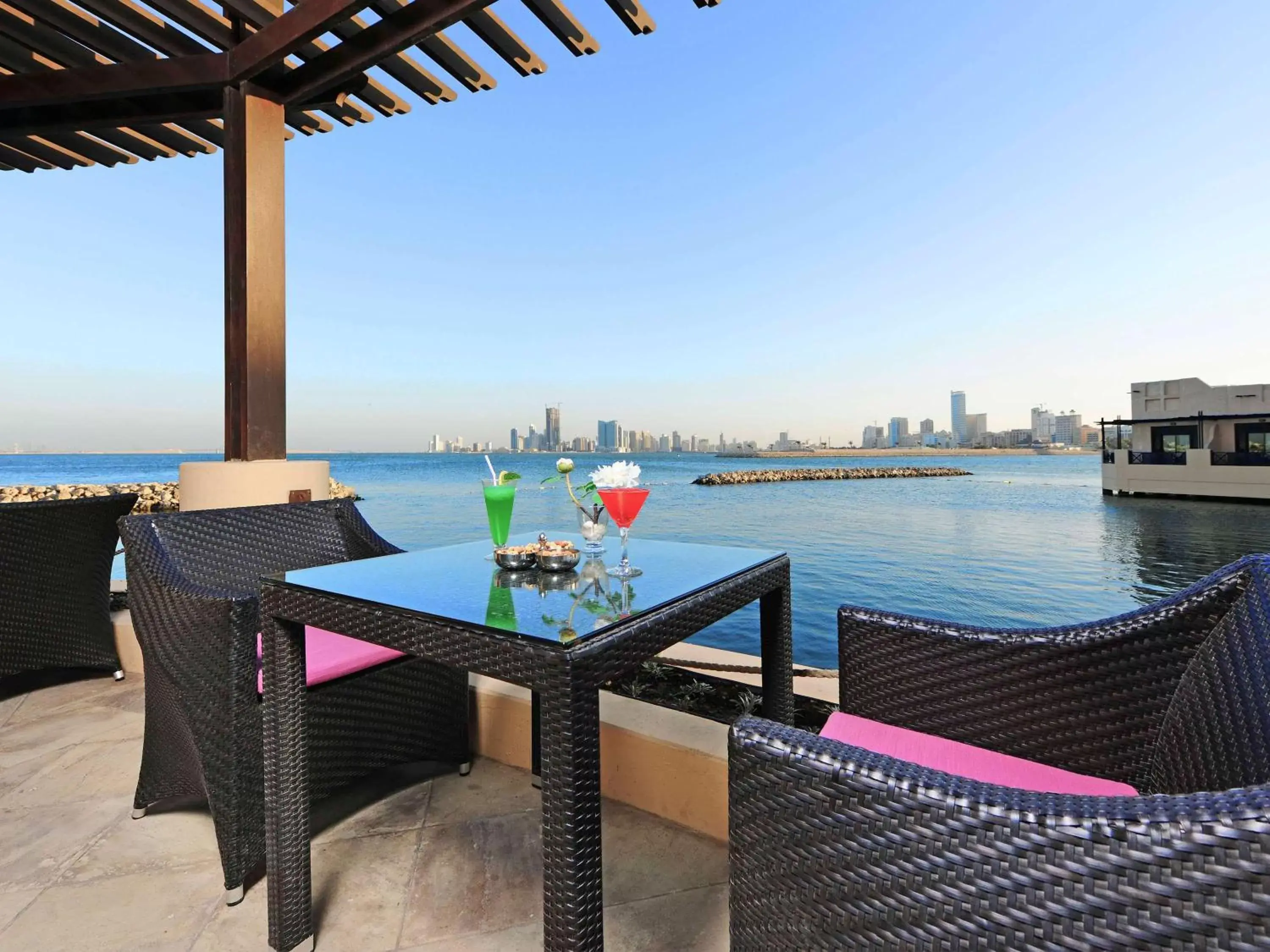 Lounge or bar, Swimming Pool in Novotel Bahrain Al Dana Resort