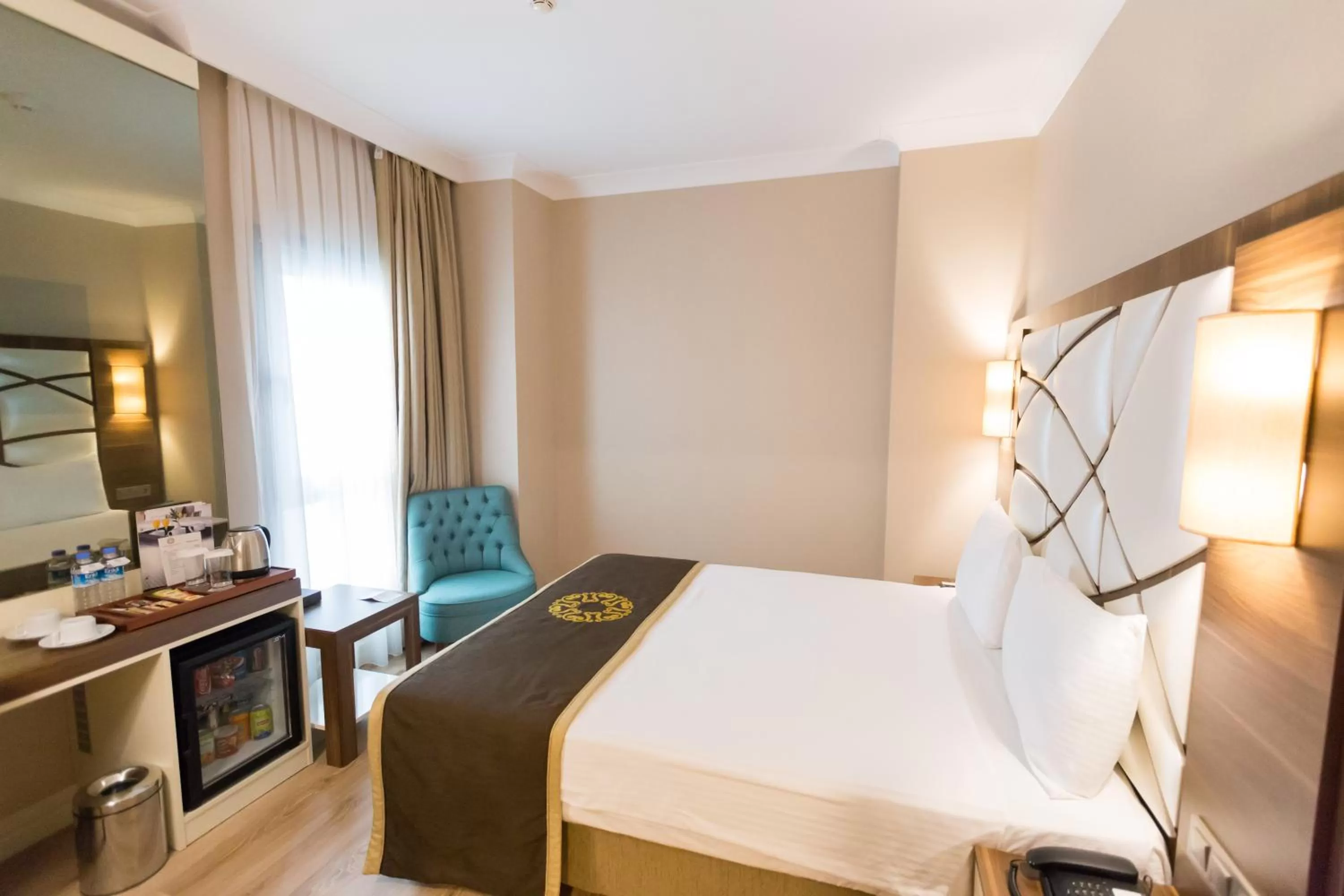 Bed in The Grand Mira Business Hotel